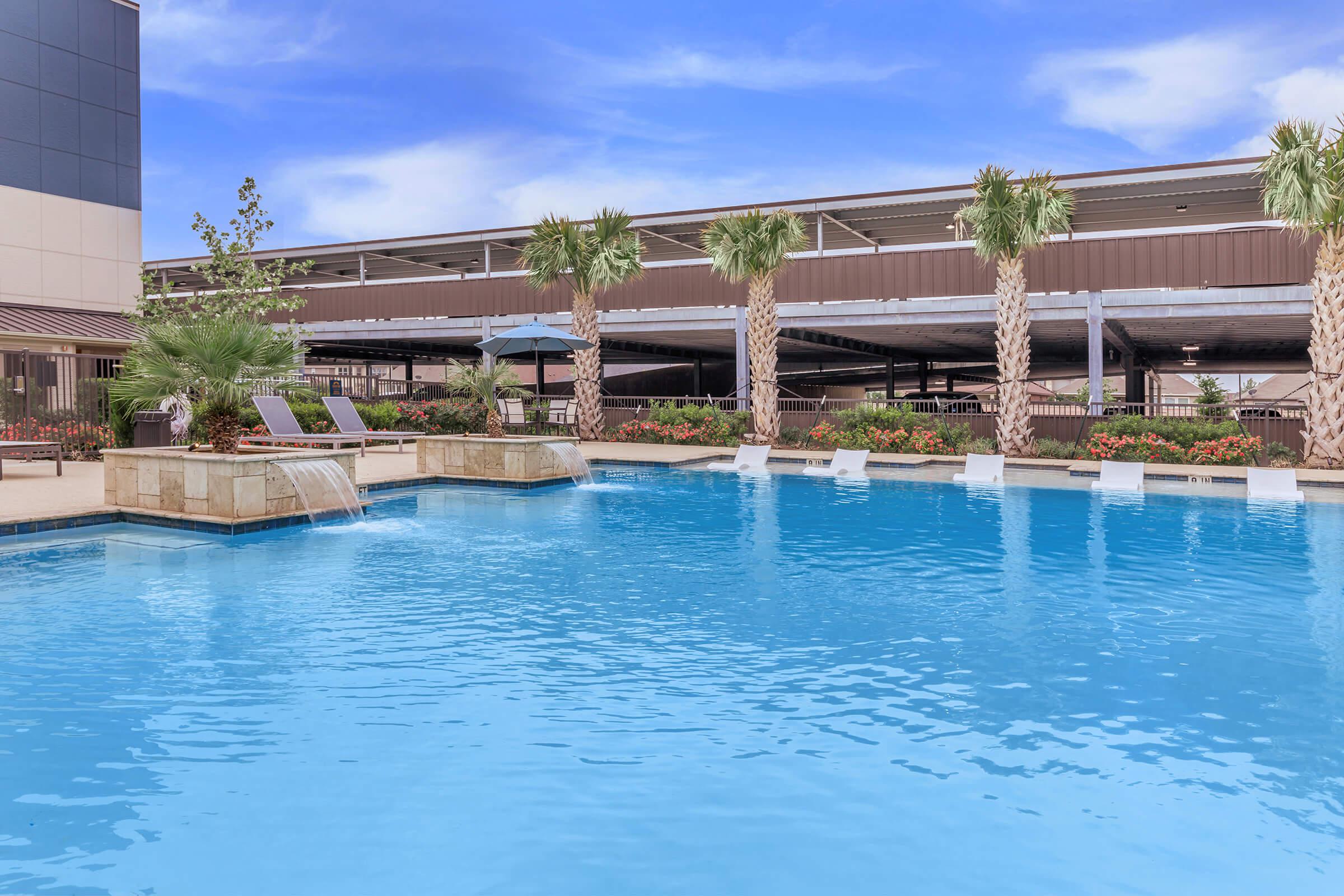 RELAX NEAR OUR SPARKLING SWIMMING POOL AT OUR POOLSIDE LOUNGE AREA