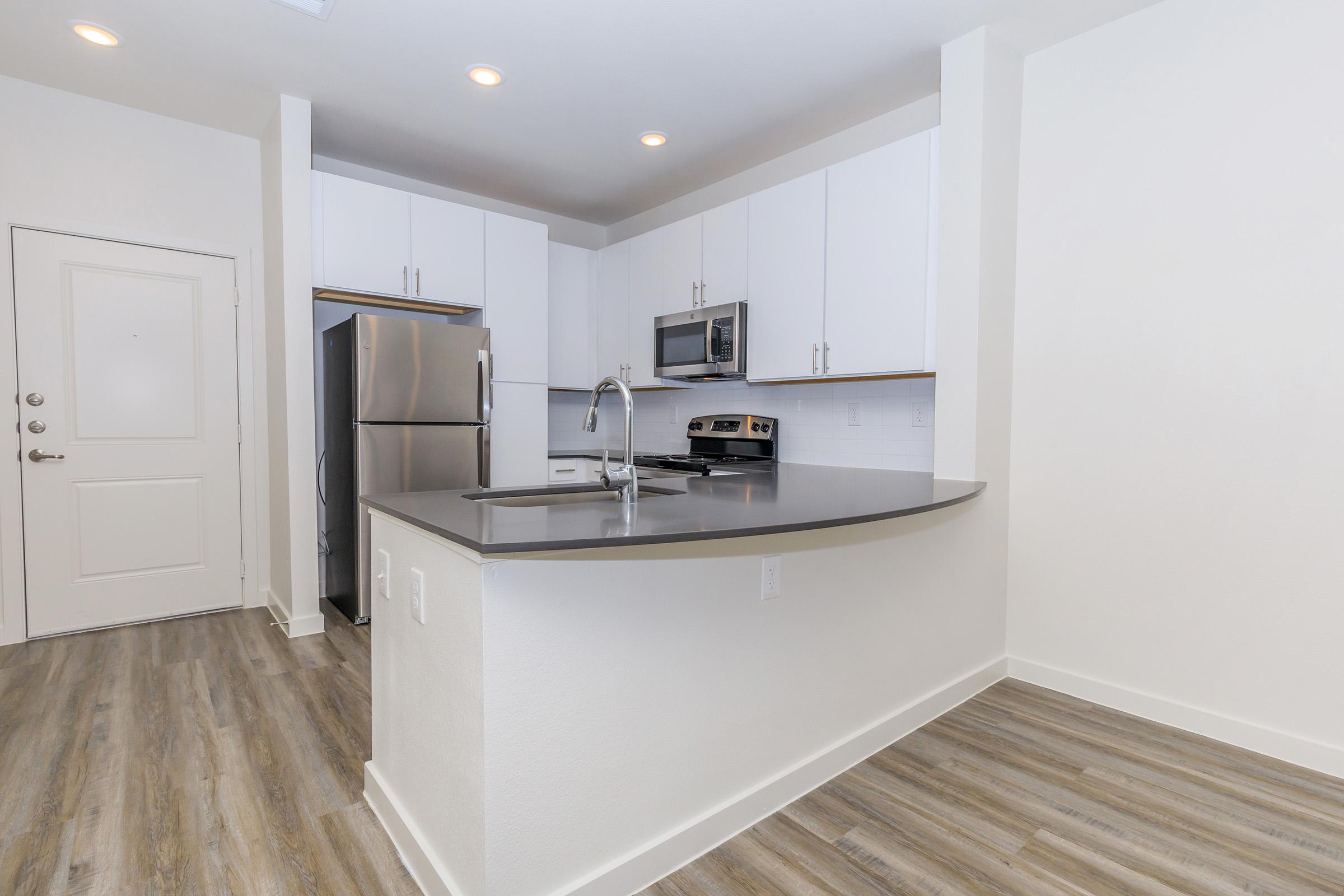 a kitchen with a wood floor