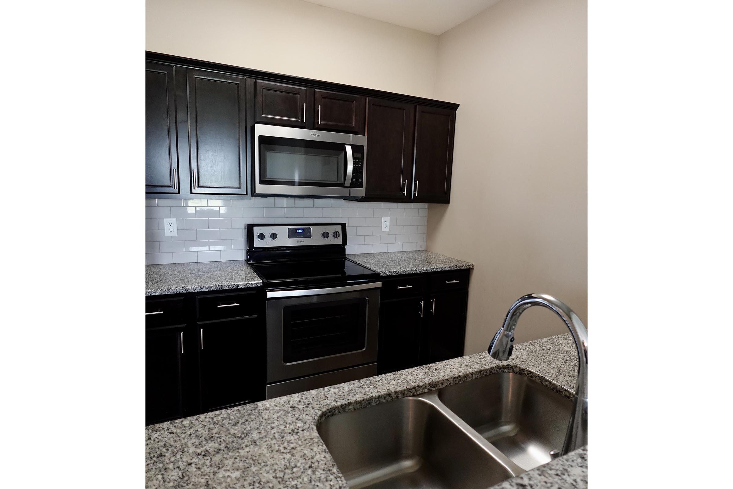 a stove top oven sitting inside of a kitchen