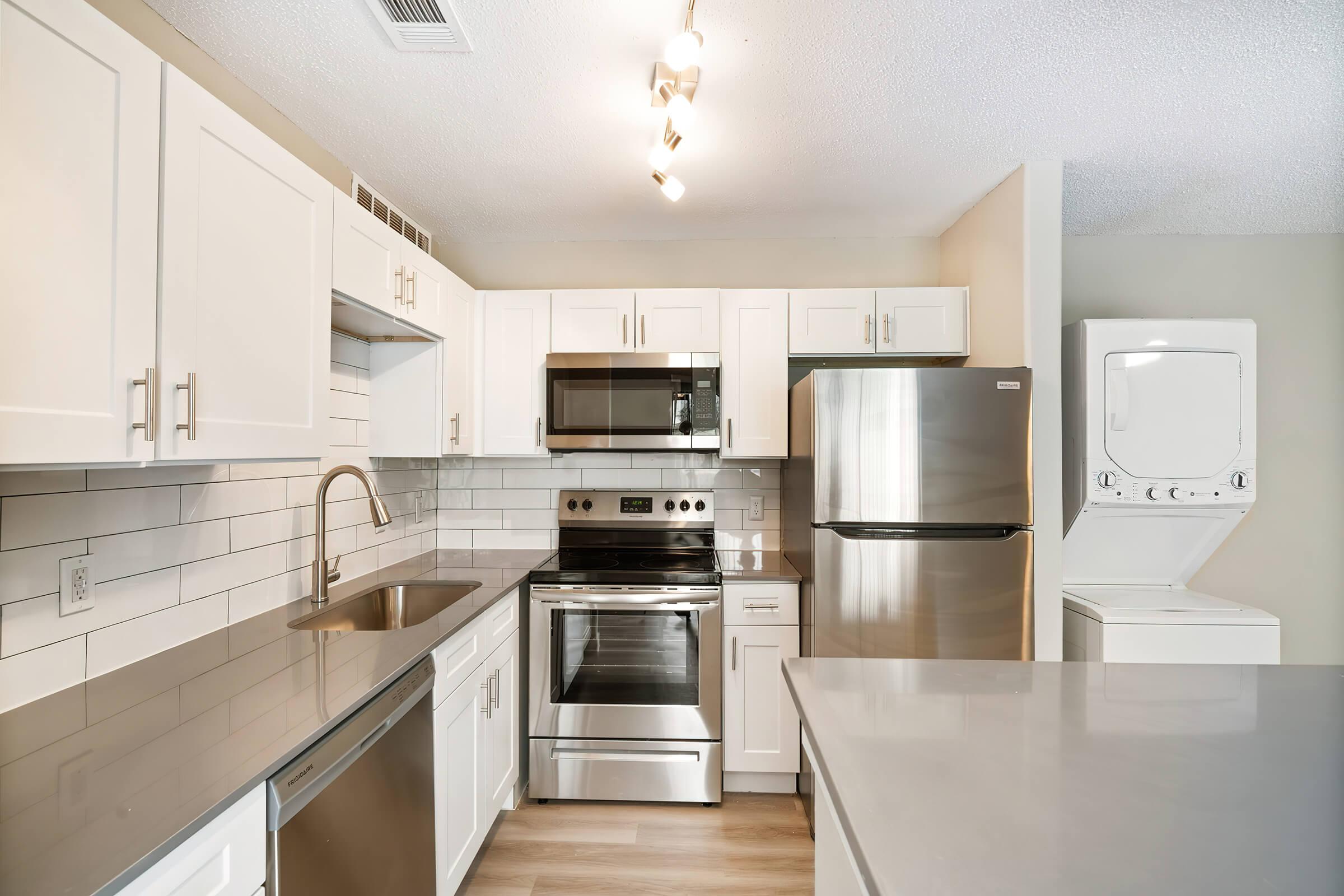 a large kitchen with stainless steel appliances