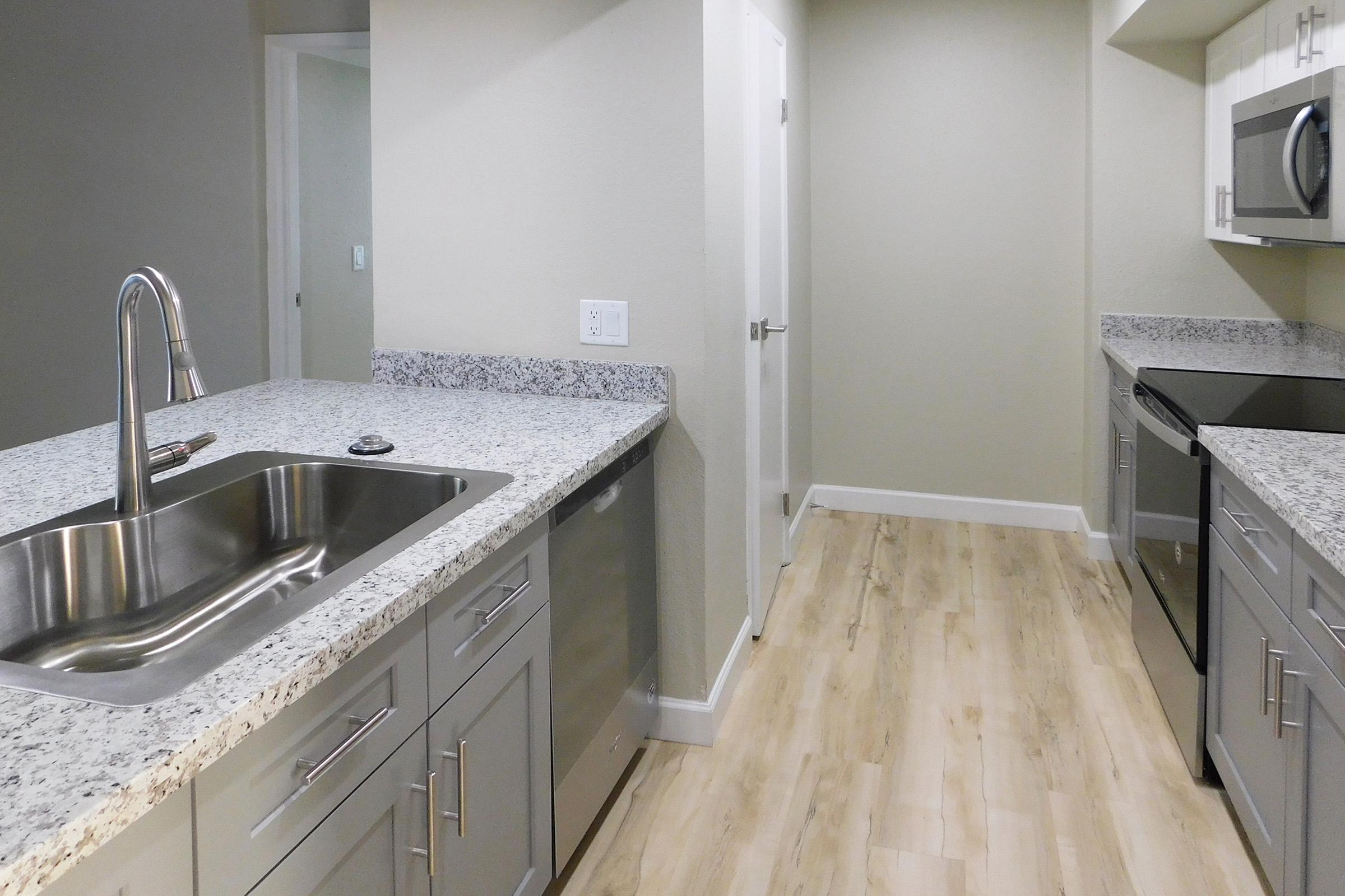 a kitchen with a sink and a mirror