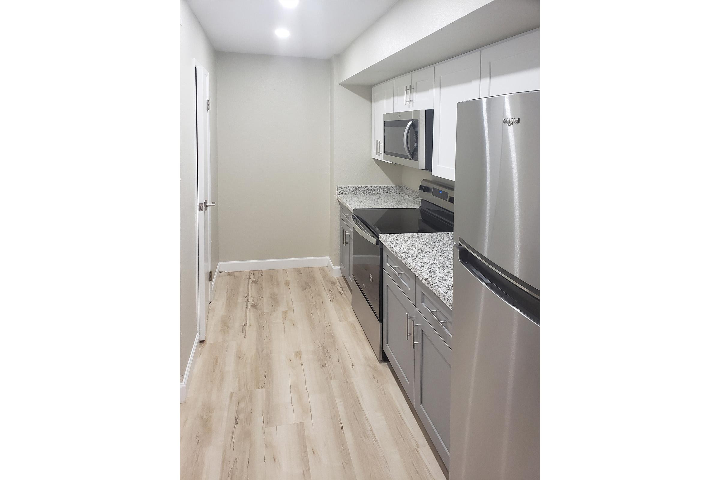 a kitchen with a sink and a refrigerator