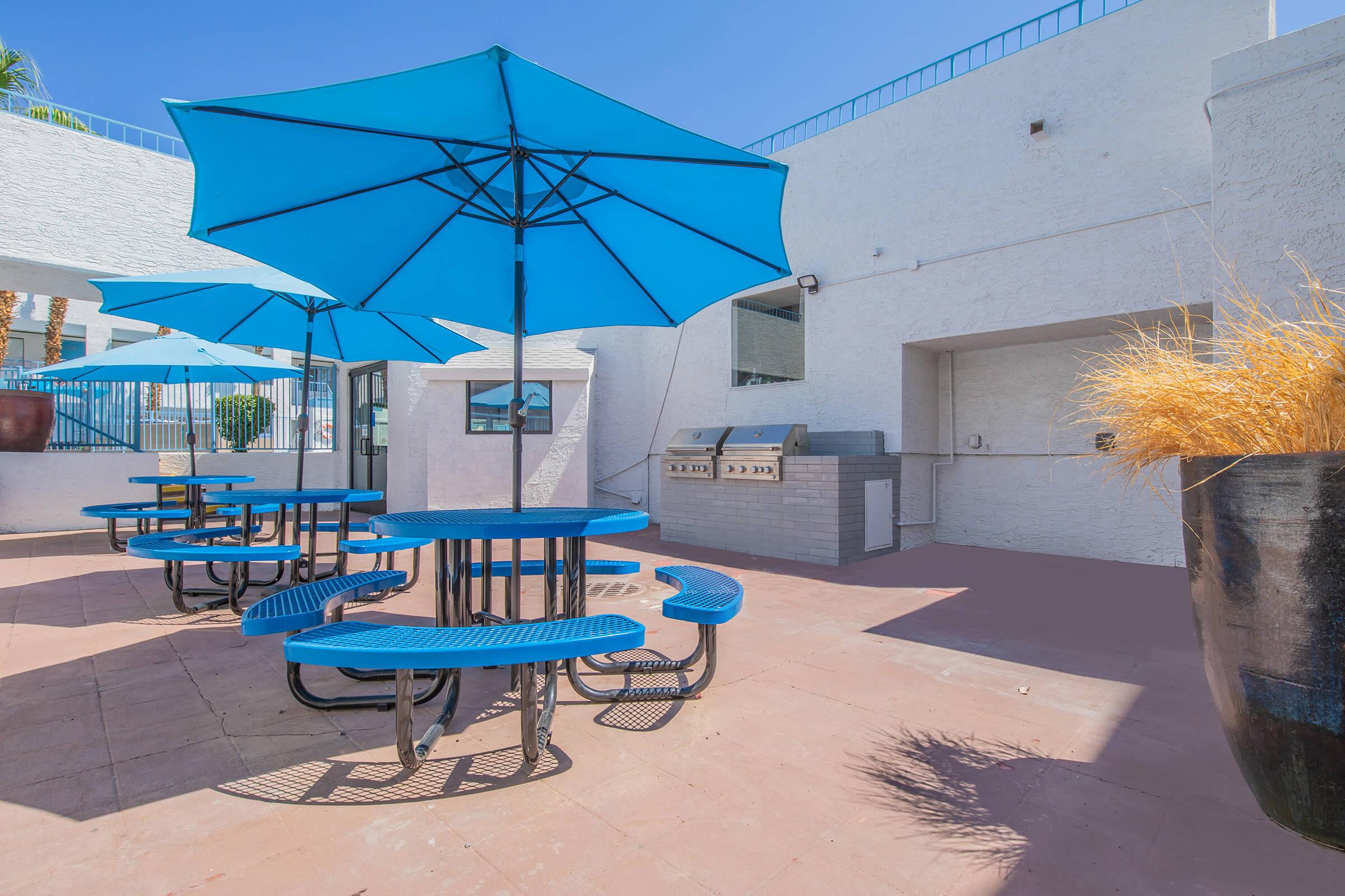 a blue bench in front of a building