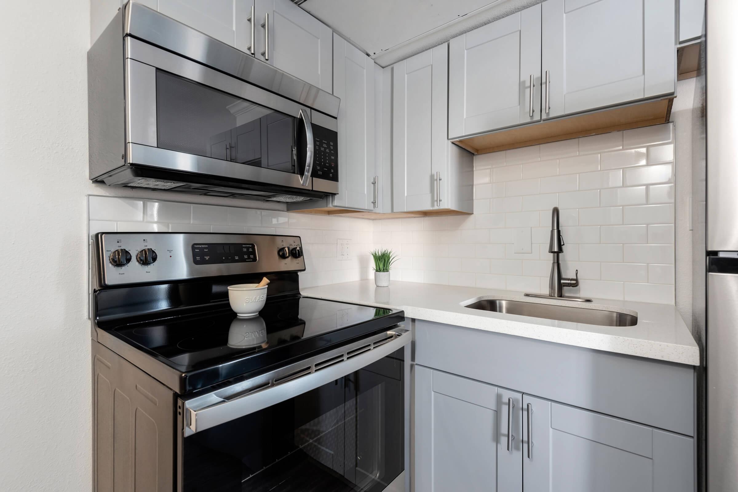 a stove top oven sitting inside of a kitchen