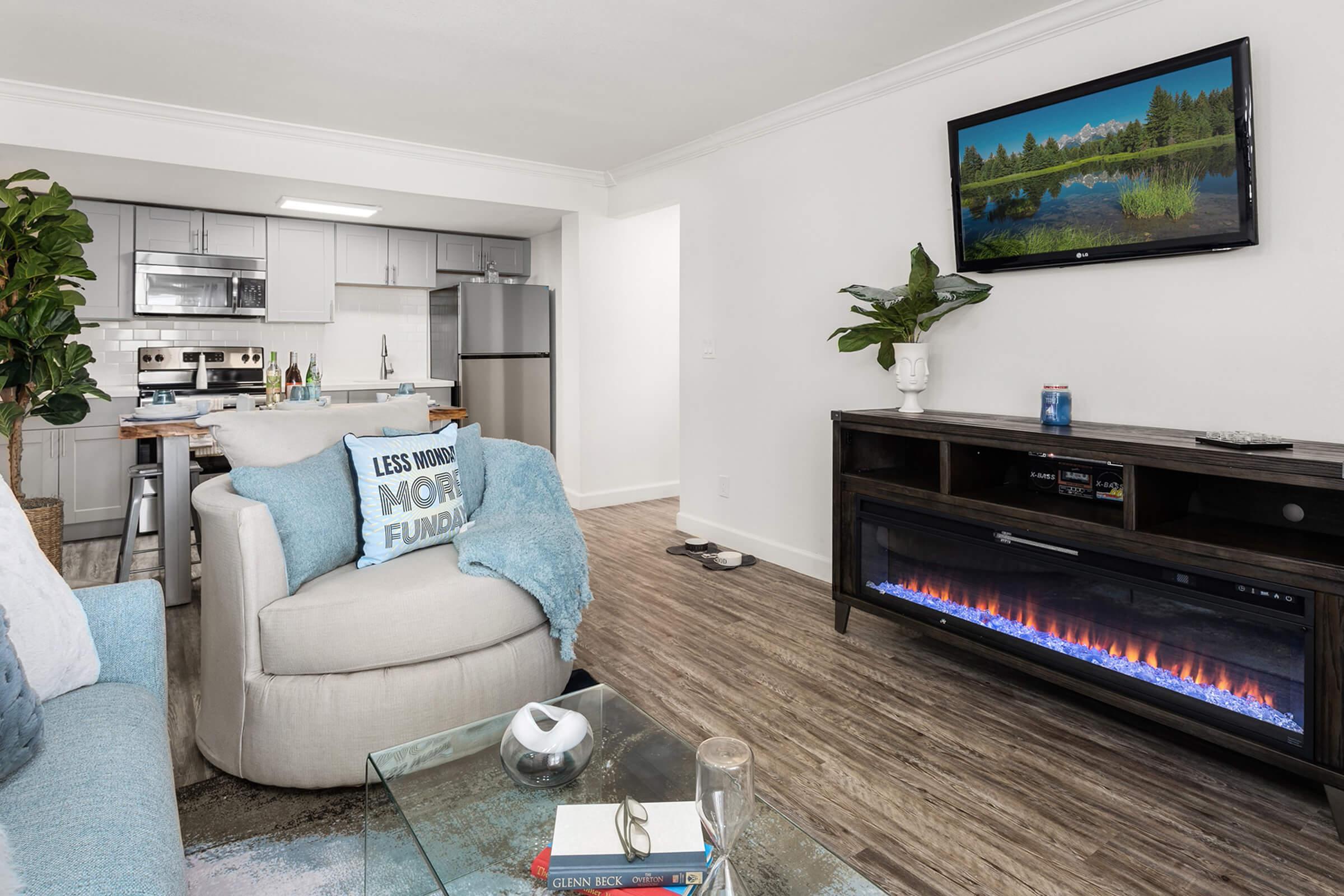 a living room filled with furniture and a flat screen tv