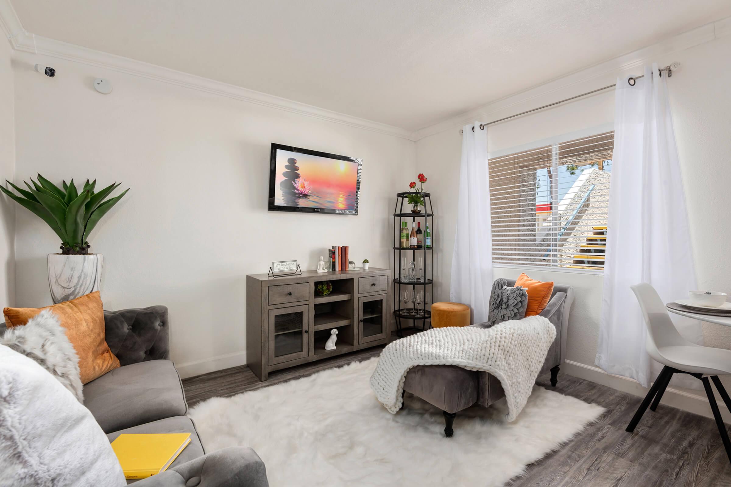 a living room filled with furniture and a flat screen tv