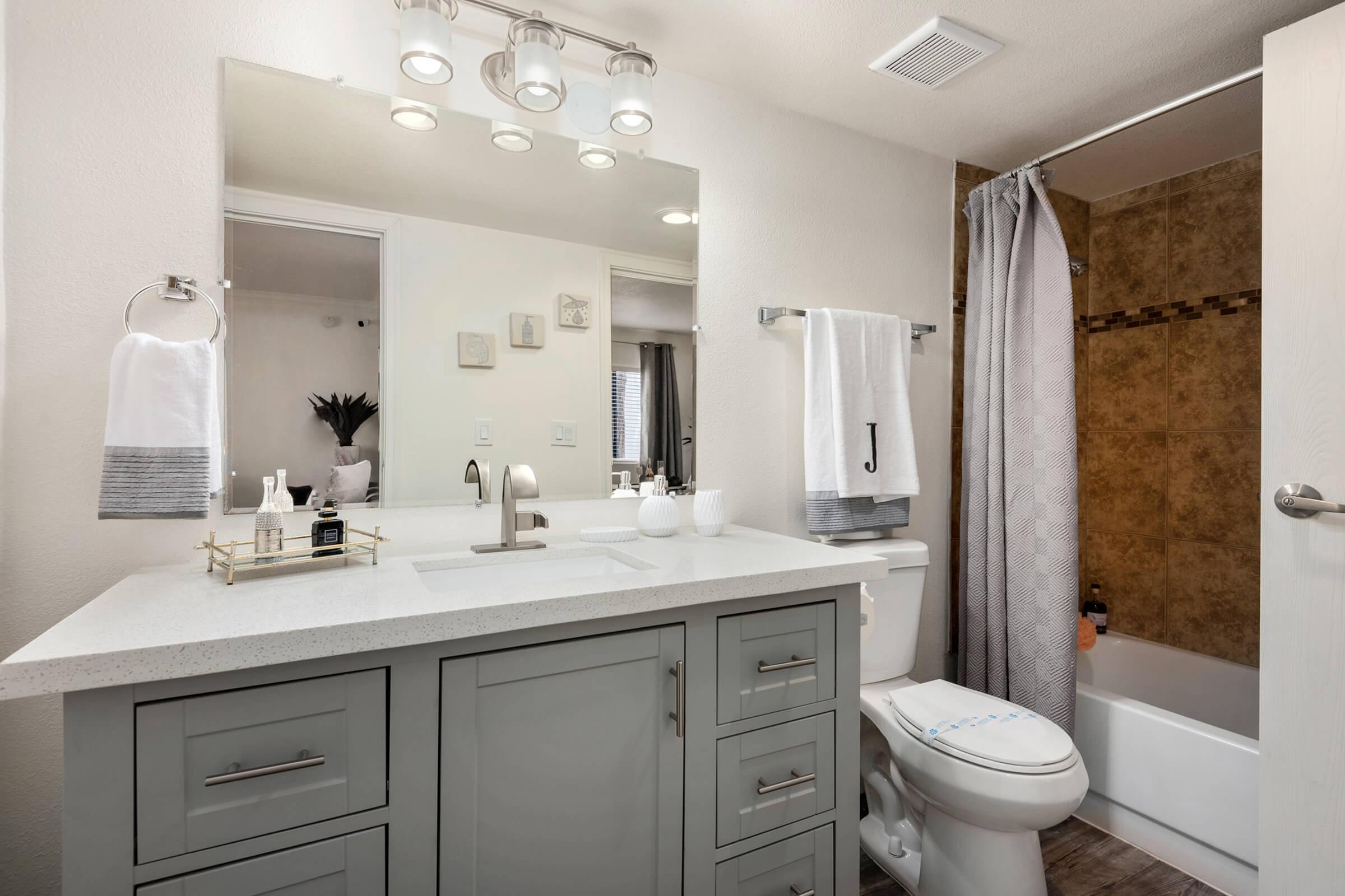 a kitchen with a sink and a mirror