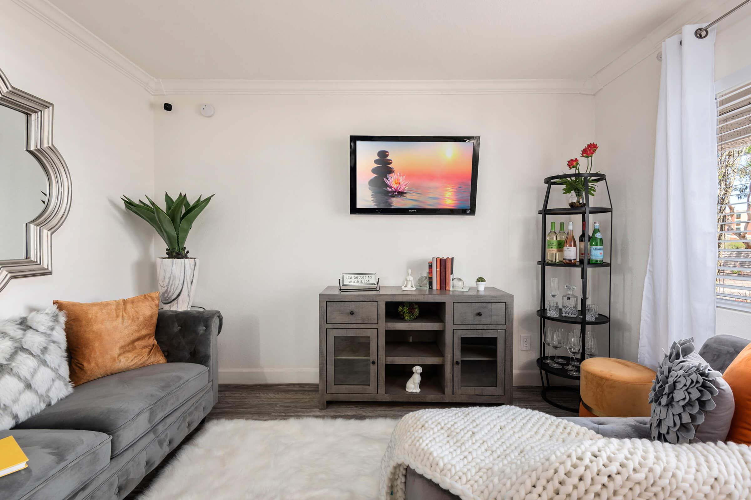 a living room filled with furniture and a flat screen tv