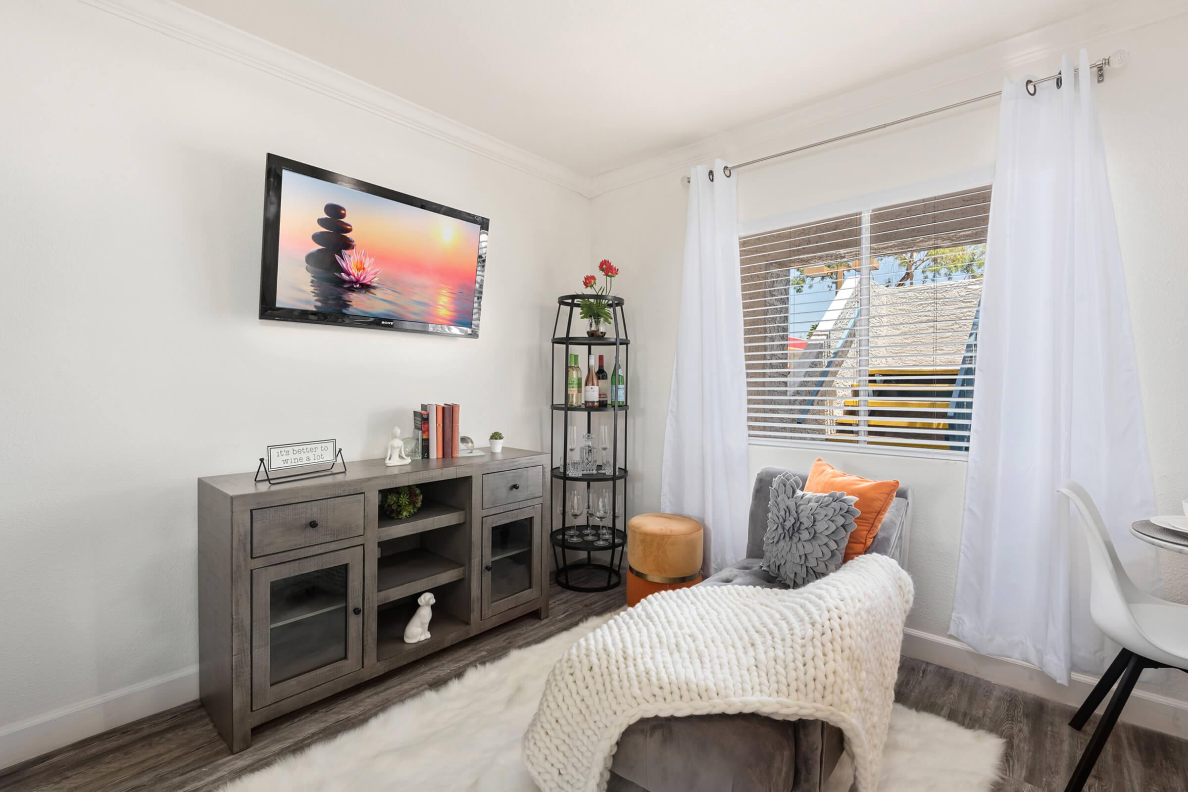 a living room filled with furniture and a flat screen tv