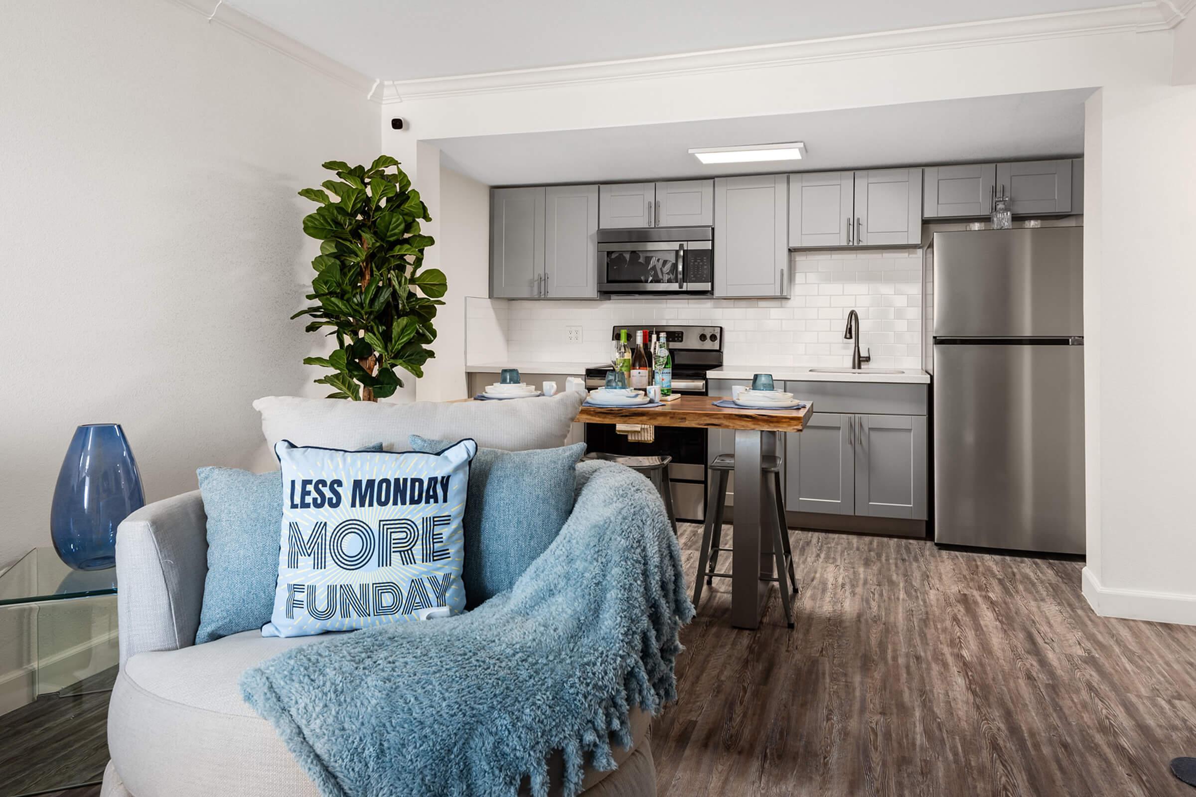 a living room filled with furniture and a large window