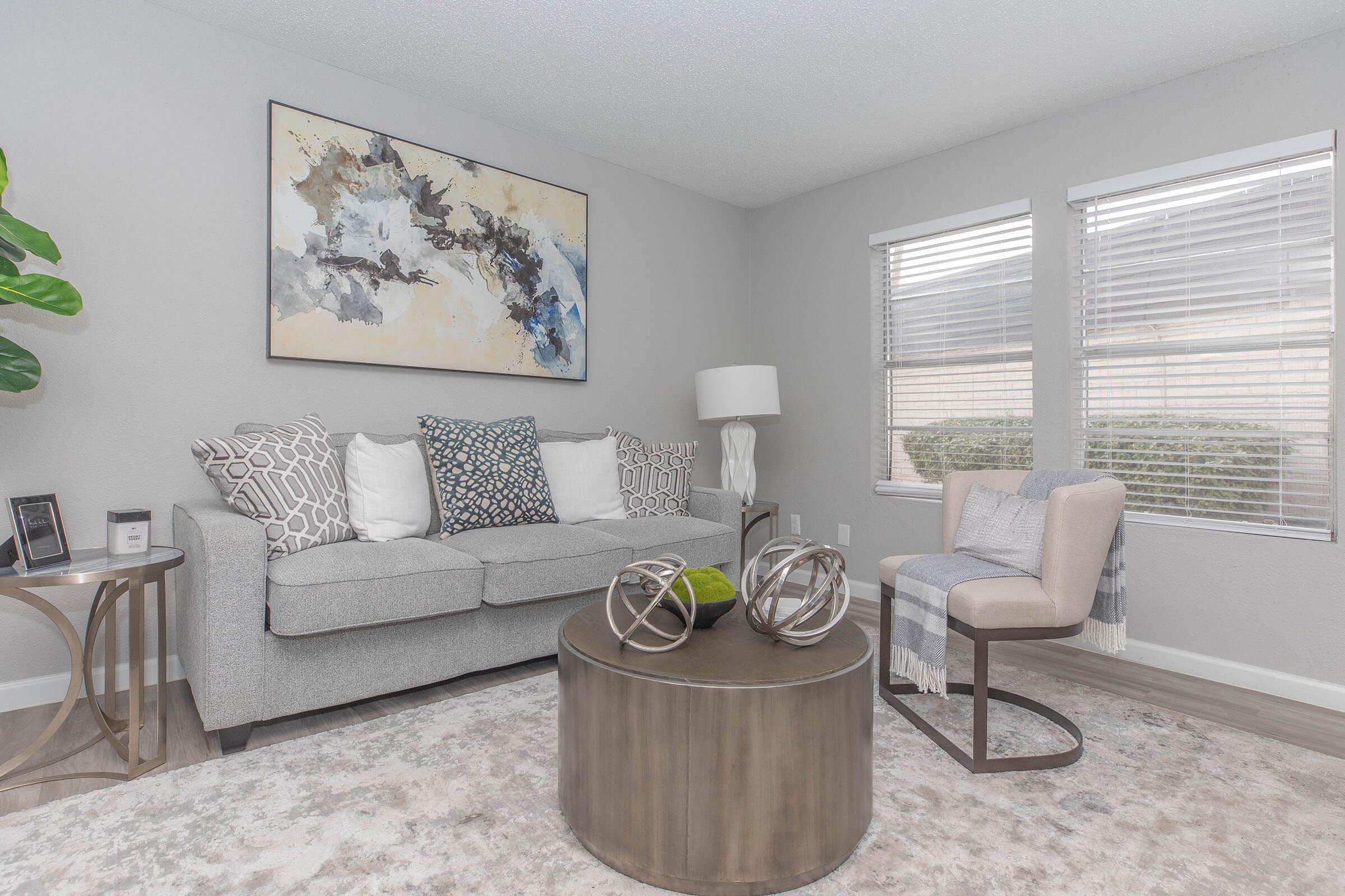 a living room filled with furniture and a large window