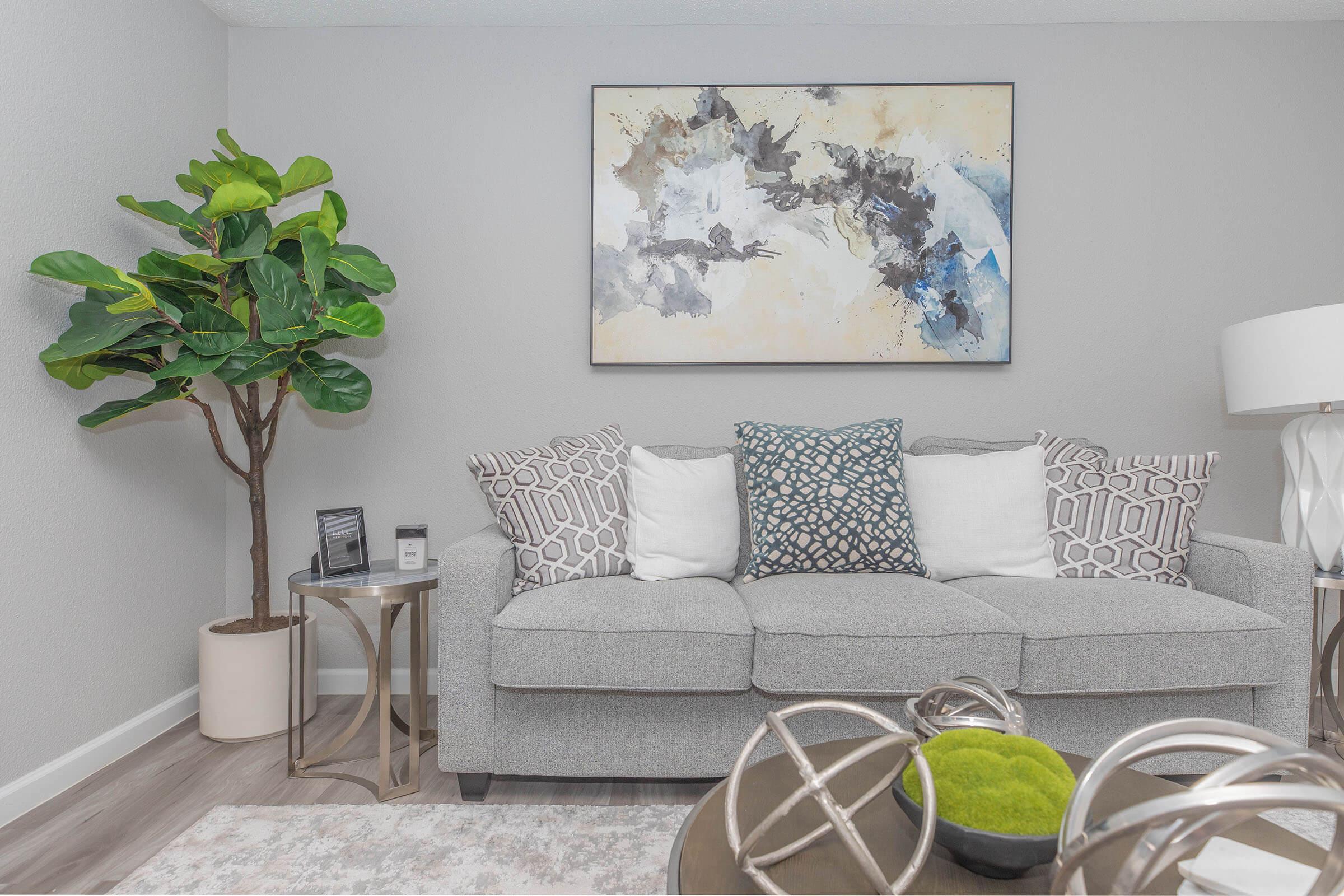 a room filled with furniture and vase of flowers on a table