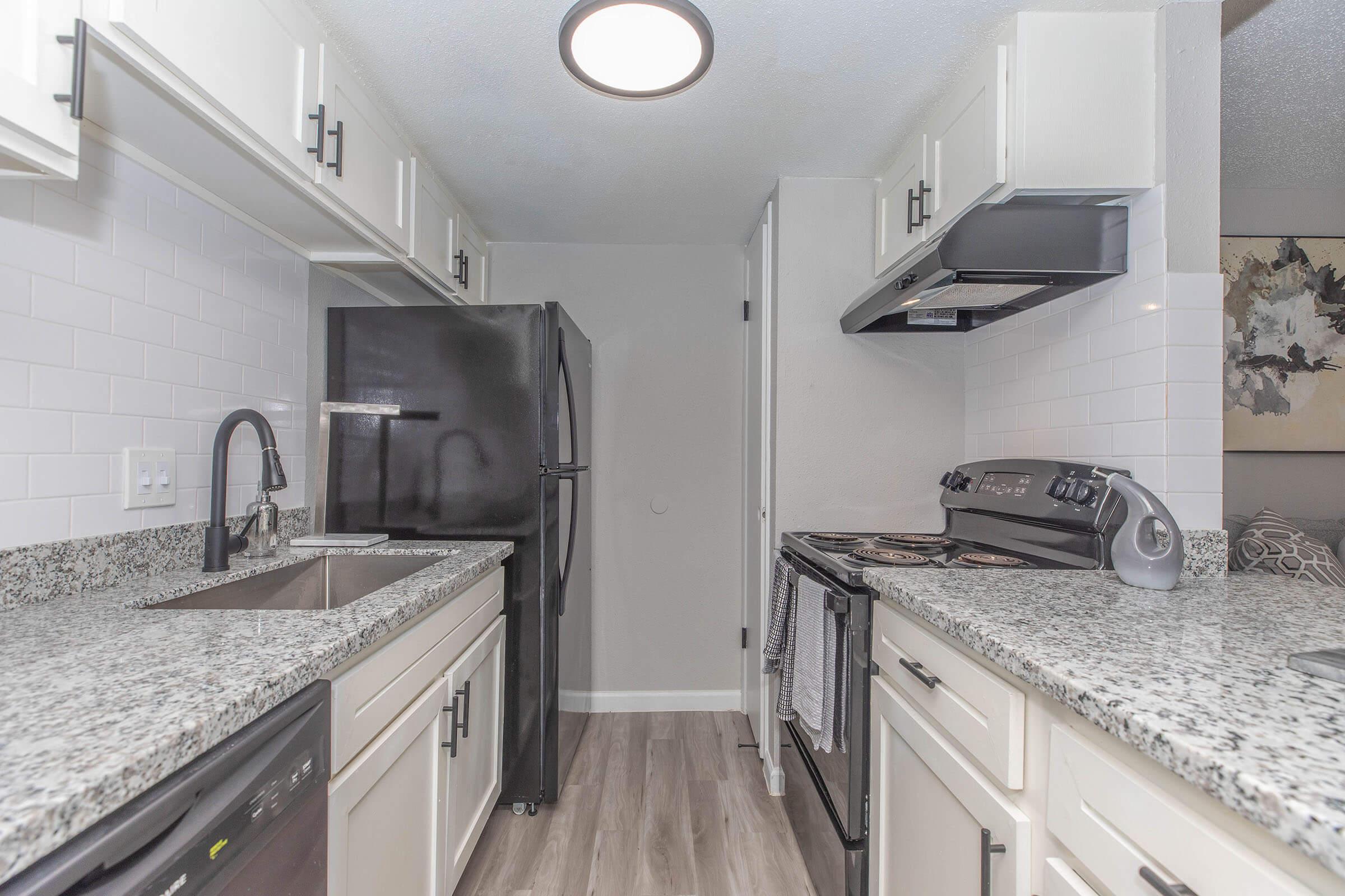 a kitchen with a stove and a sink