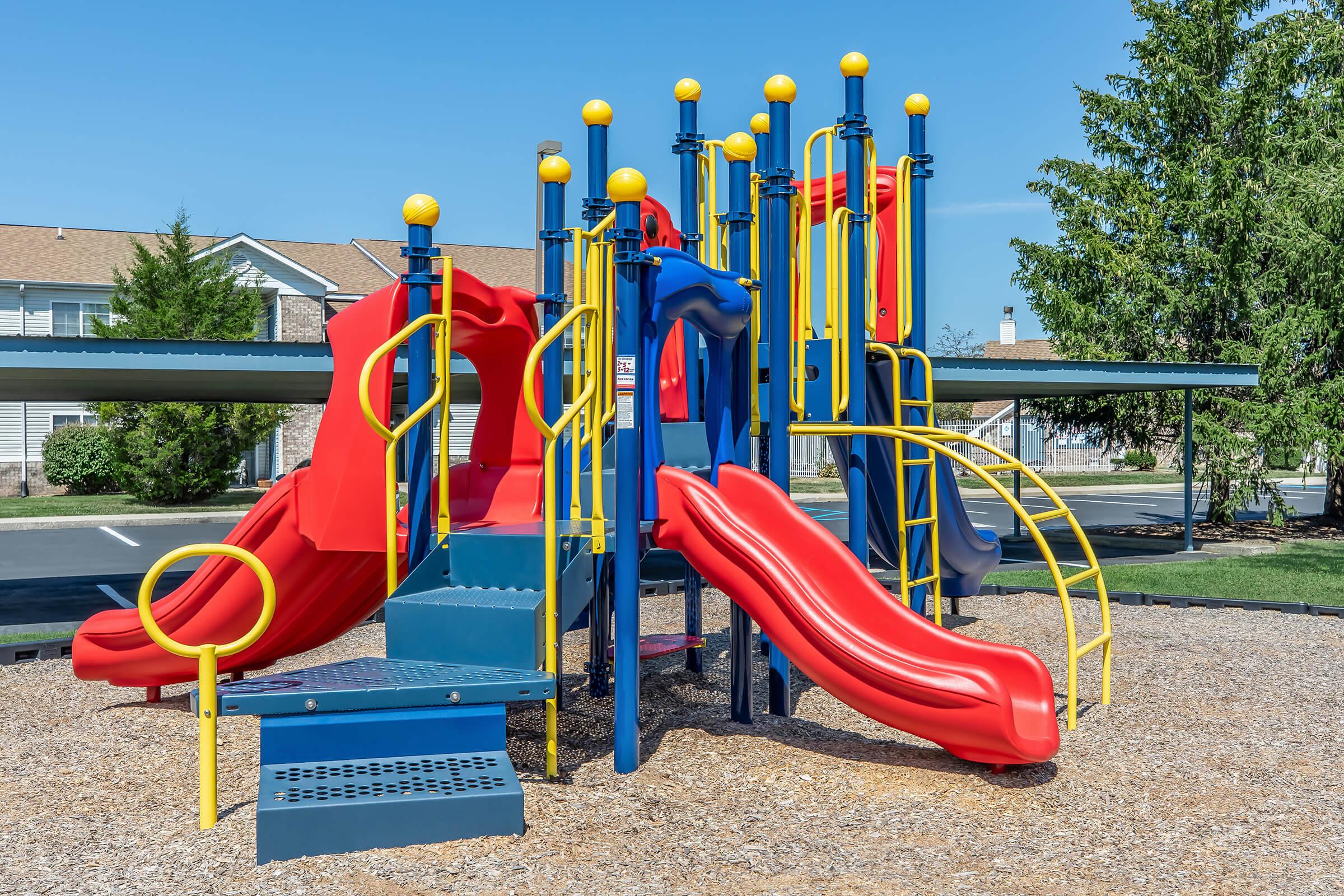 a group of lawn chairs sitting on top of a playground