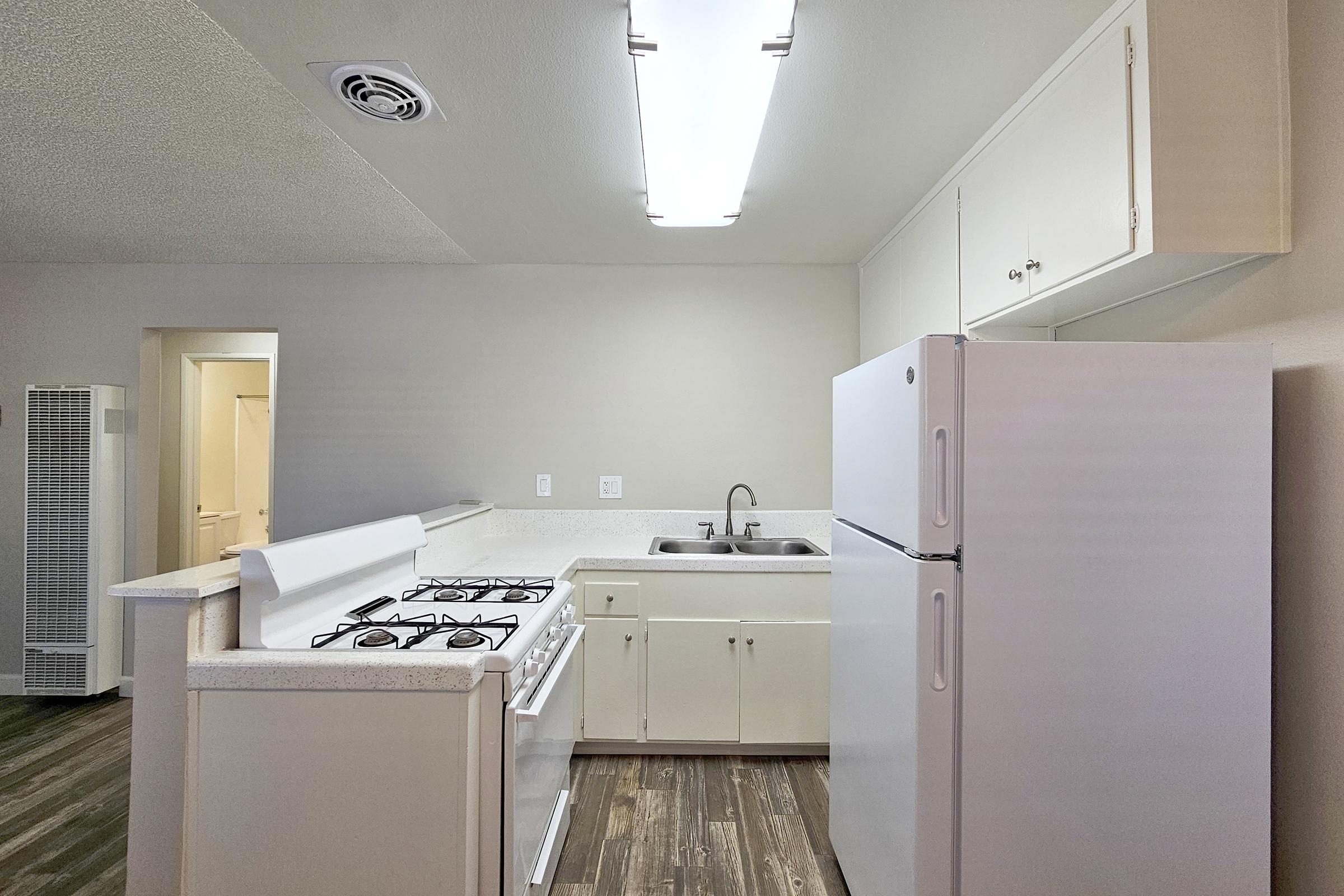 a kitchen with a sink and a mirror