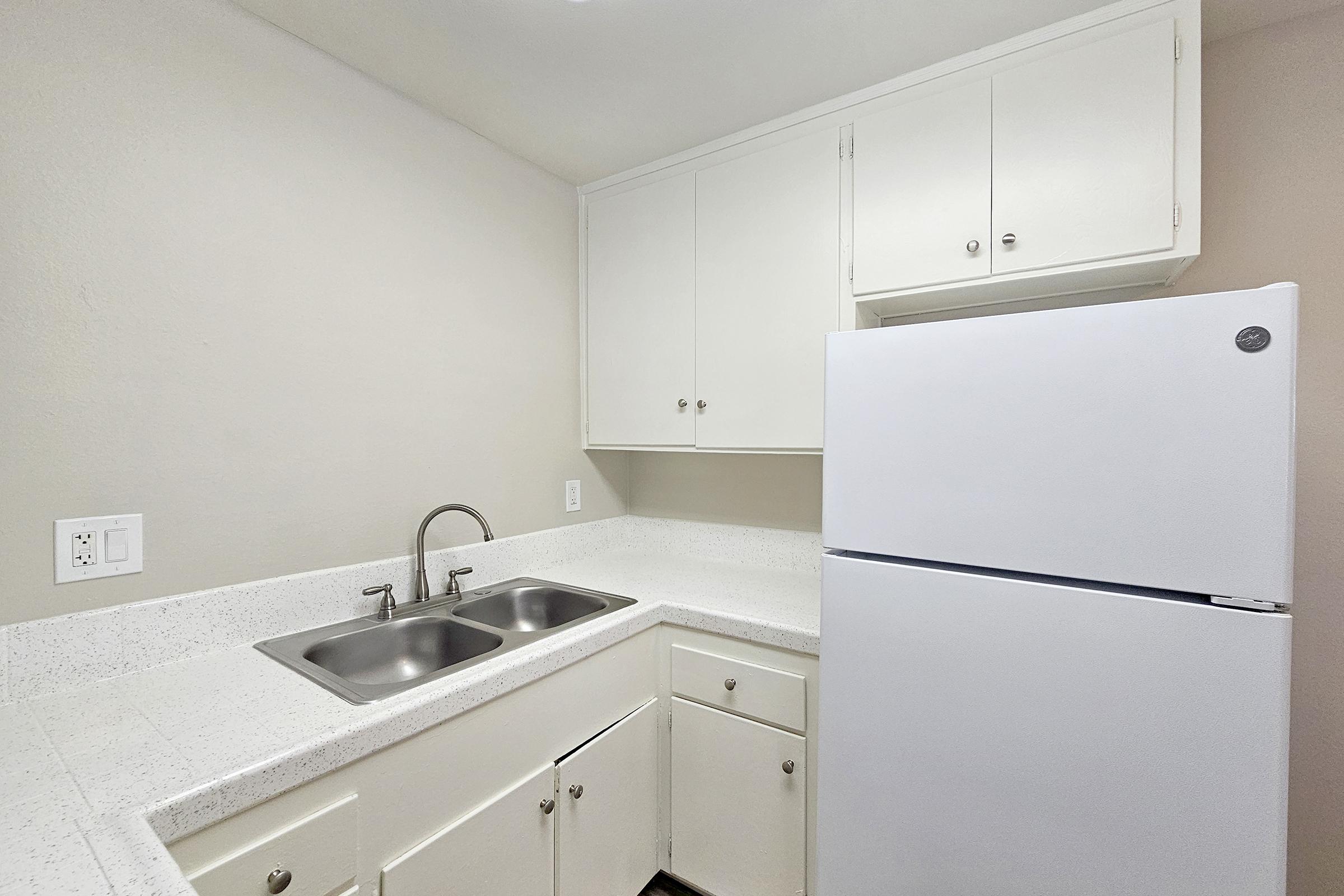 a kitchen with a sink and a refrigerator