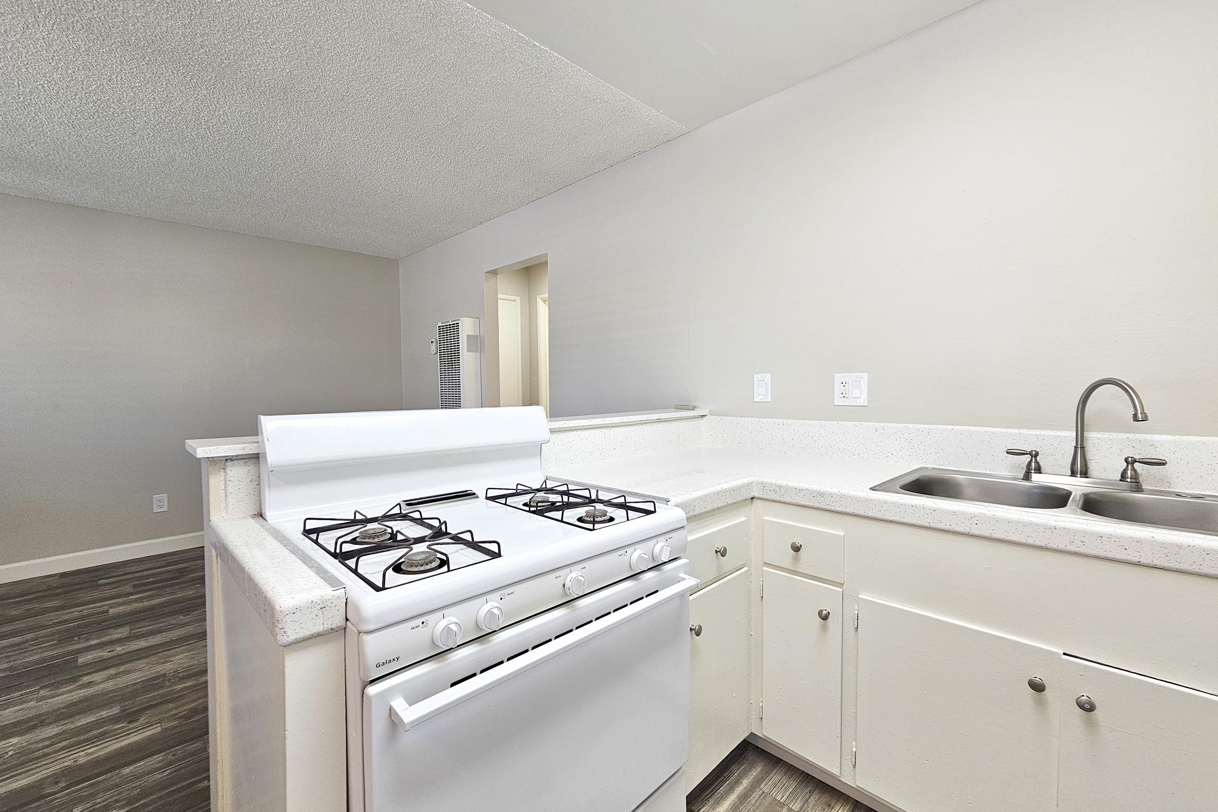 a stove top oven sitting inside of a kitchen