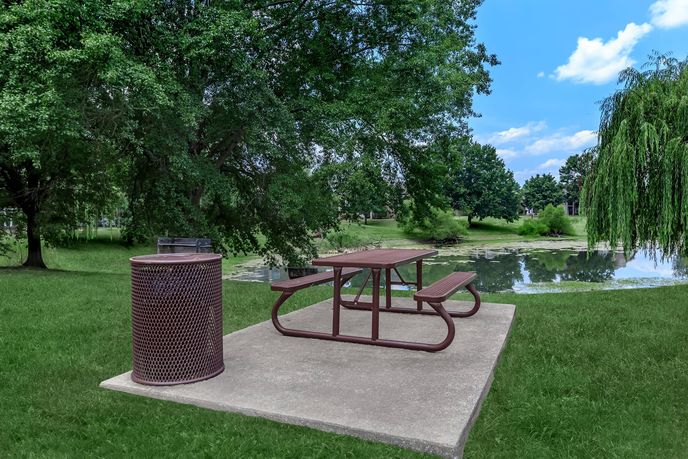 a couple of lawn chairs sitting on top of a bench in a park