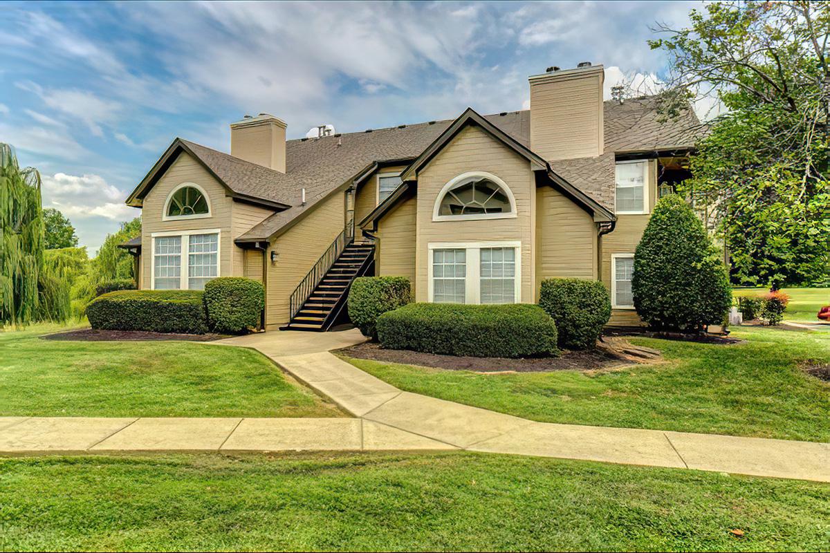 a large lawn in front of a house with Eudora Welty House in the background