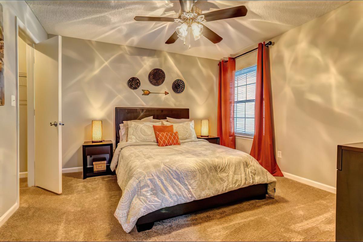 a bedroom with a bed and desk in a room