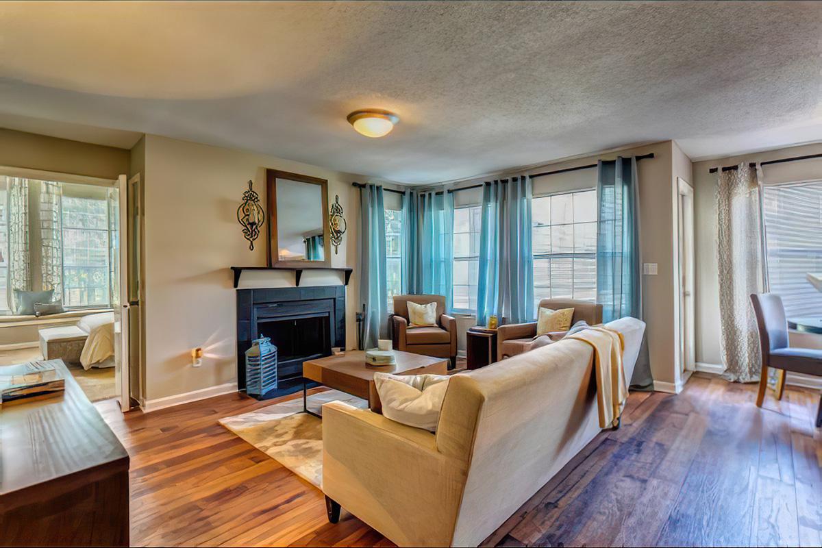 a living room filled with furniture and a large window