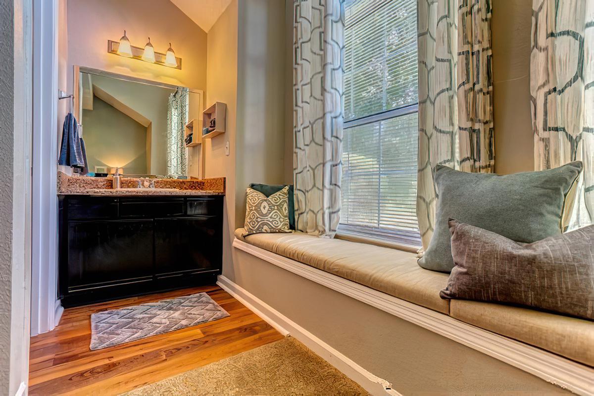 a living room filled with furniture and a large window