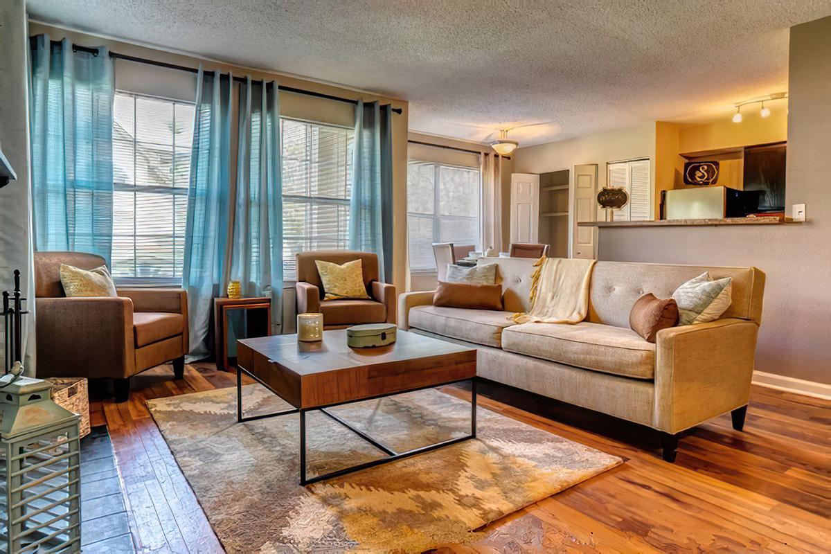 a living room filled with furniture and a large window