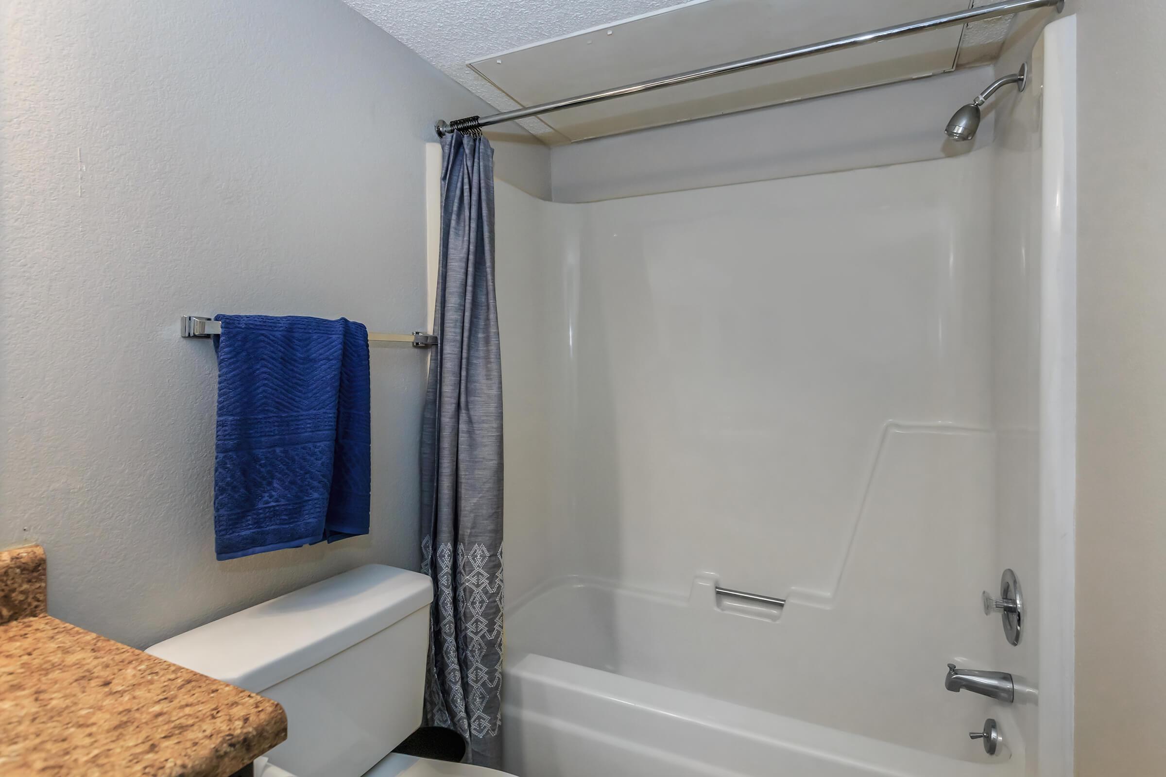 a room with a tub and shower curtain