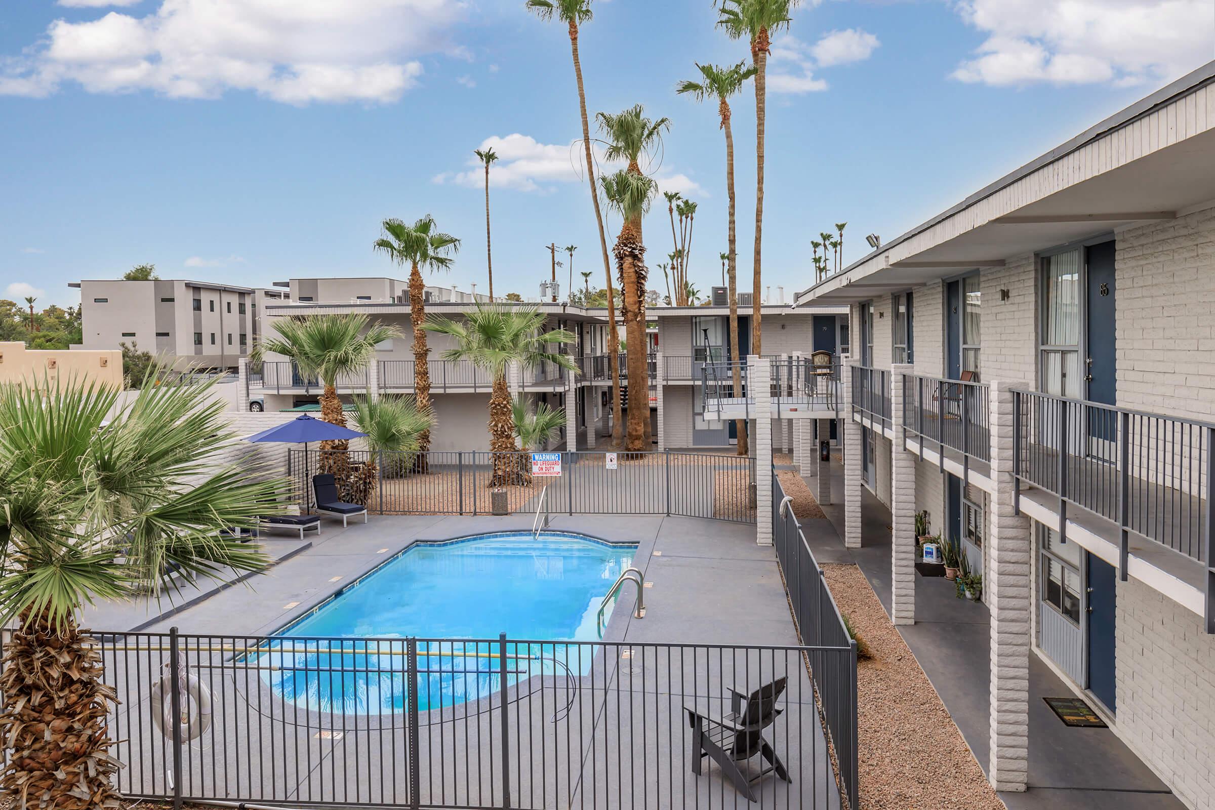 a house with a pool in front of a building