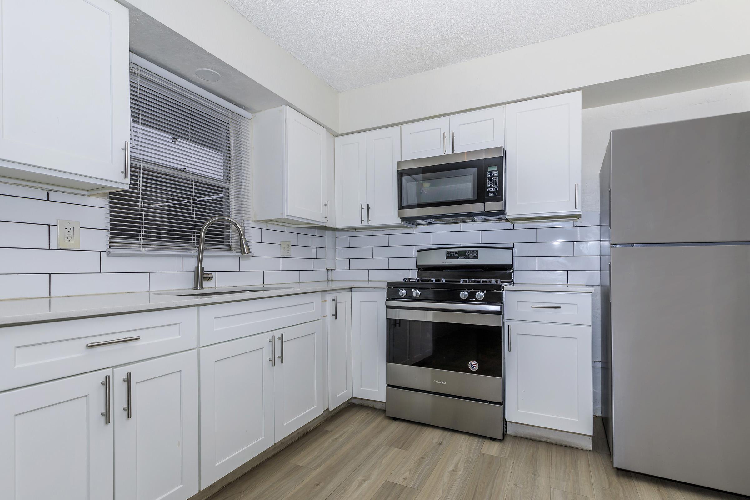 a kitchen with a stove and a refrigerator