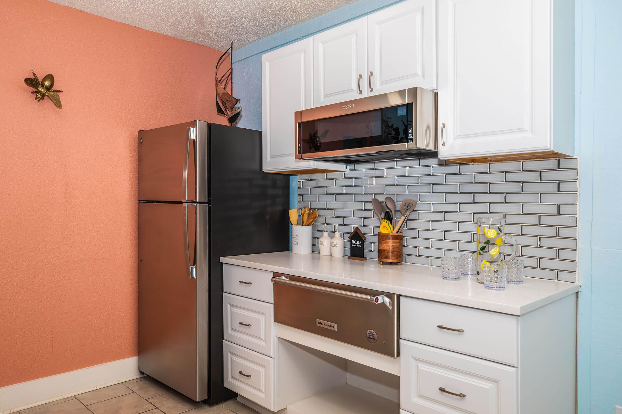 a kitchen with a stove and a refrigerator