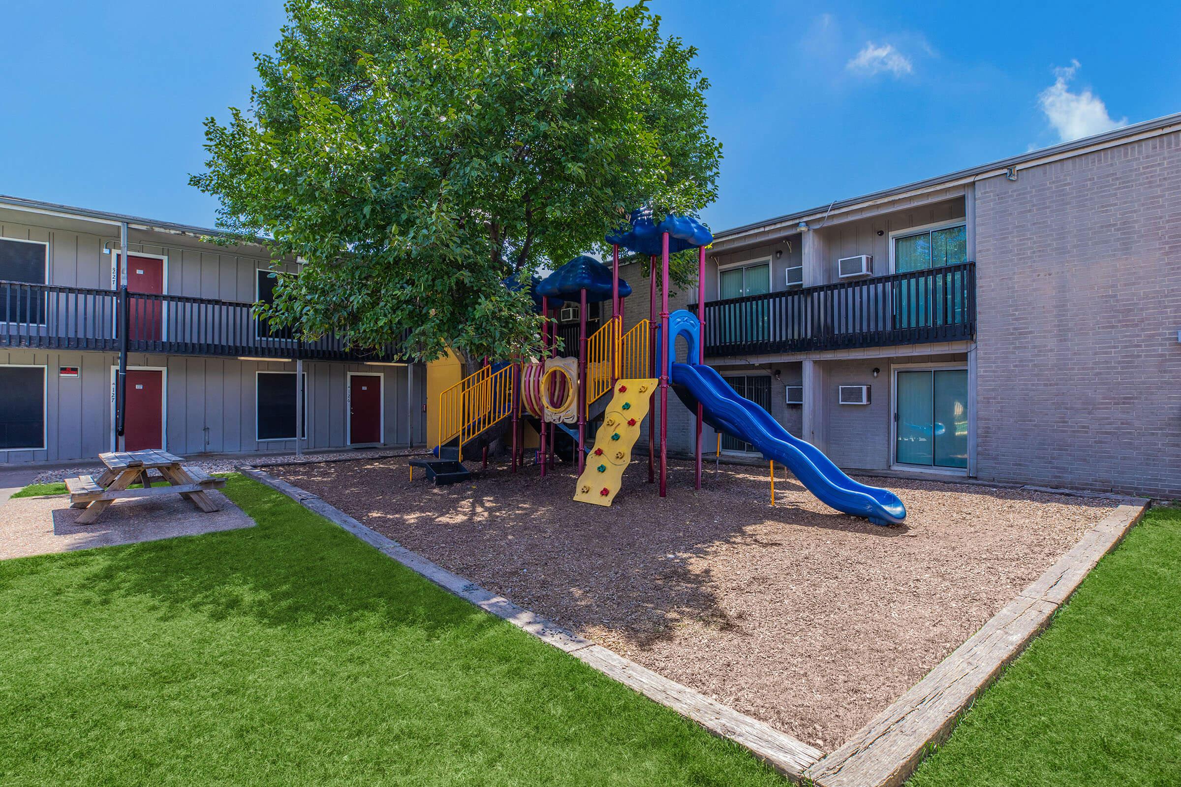 a house with a lawn in front of a building