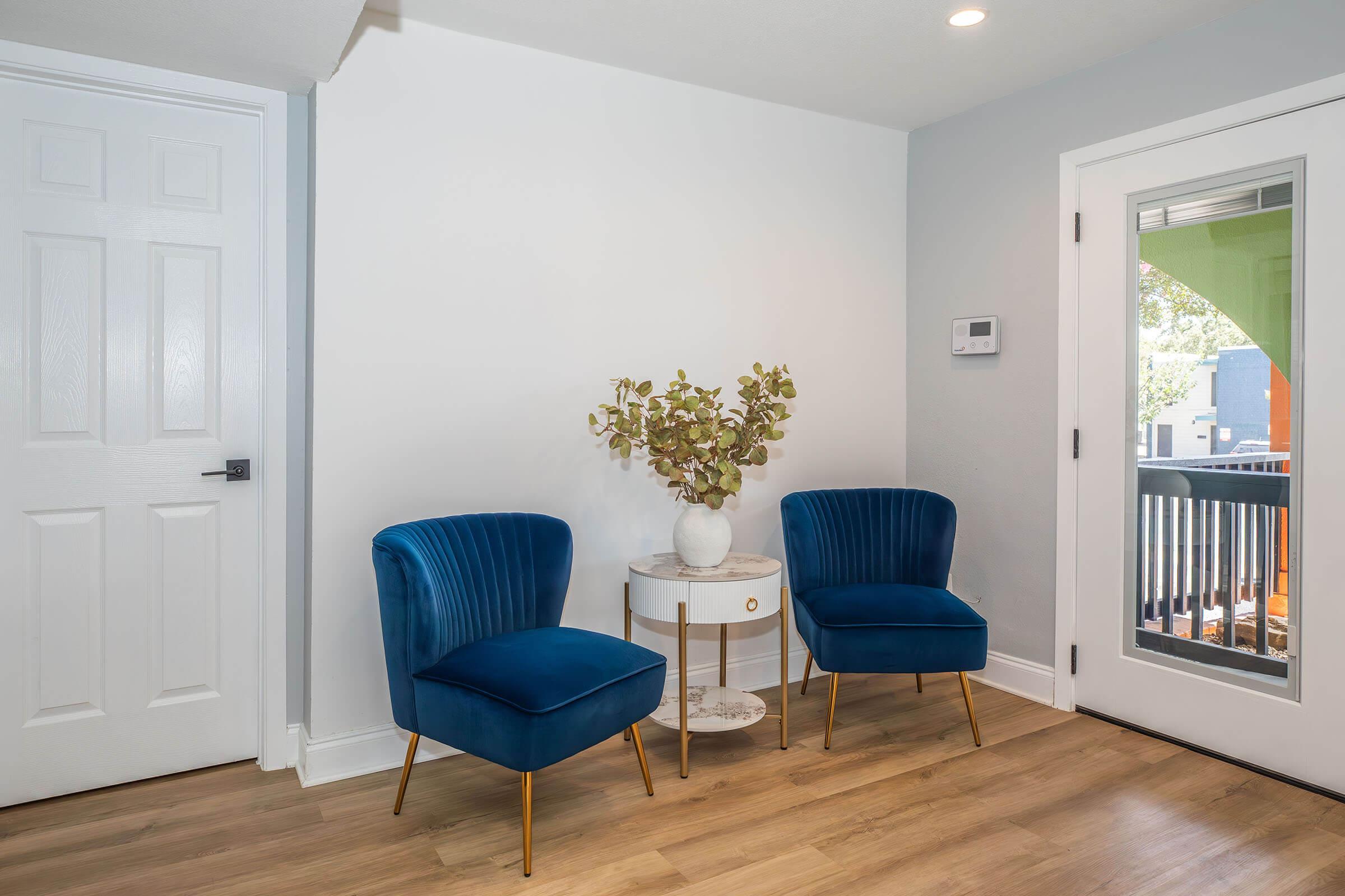 a living room with a blue chair