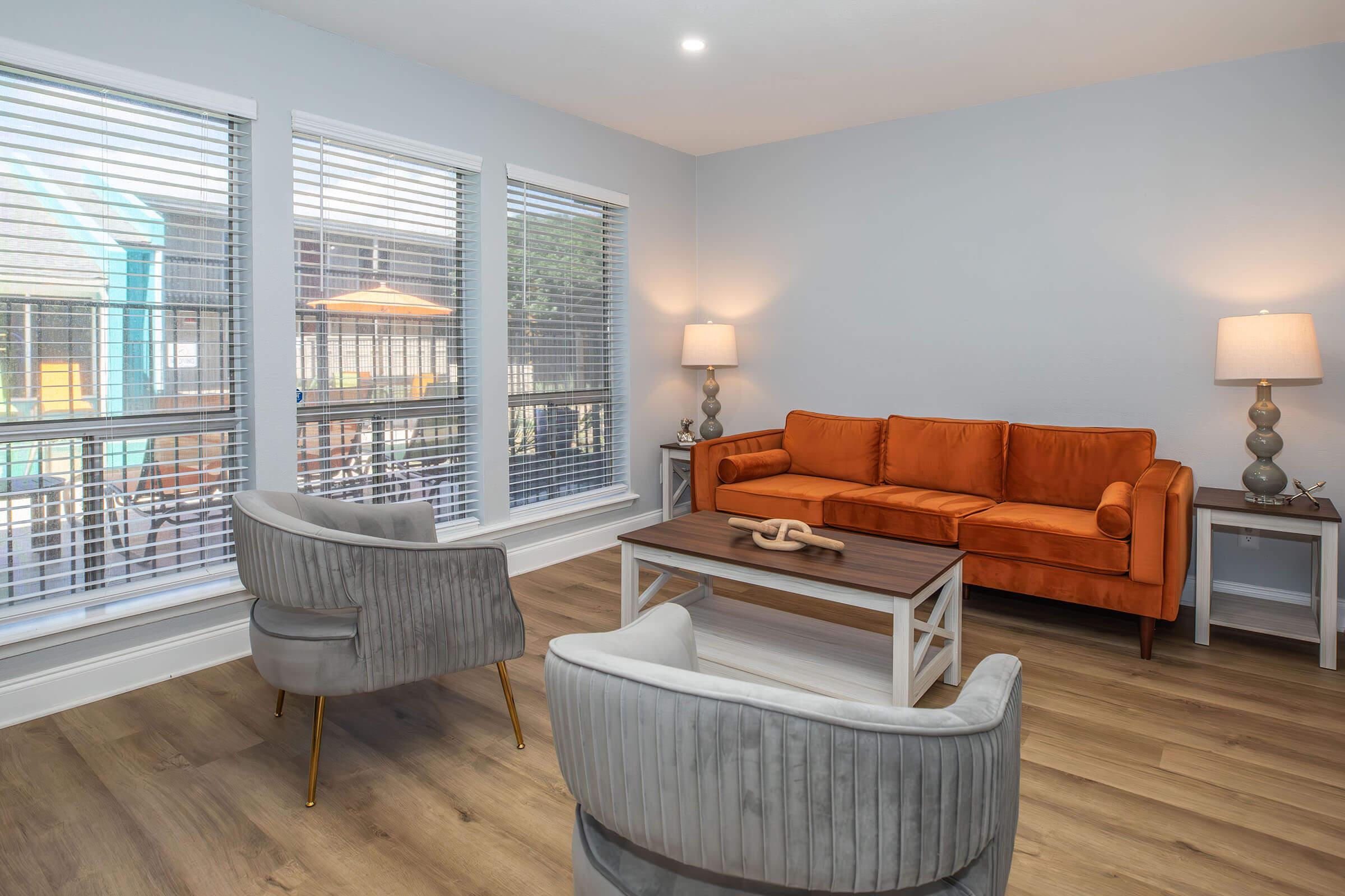 a living room filled with furniture and a large window