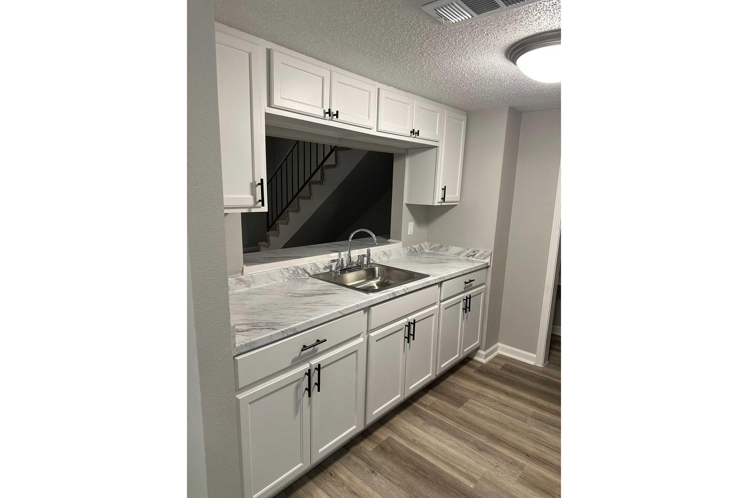 a kitchen with wooden cabinets