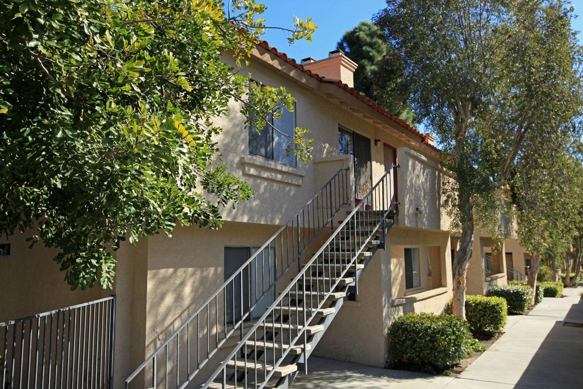 a house with bushes in the background