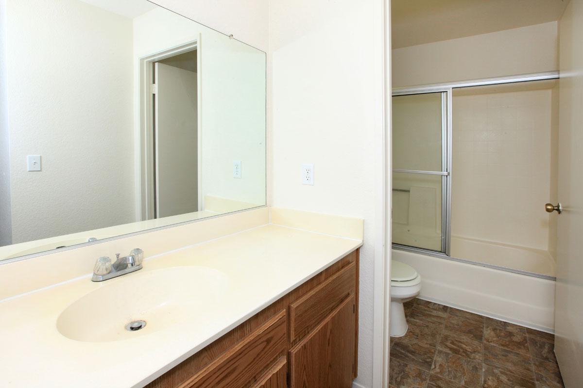 a white sink and a mirror