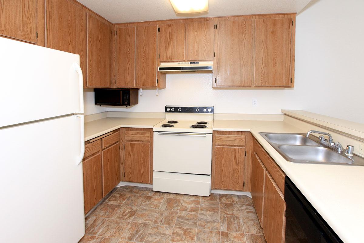 a kitchen with a stove and a refrigerator