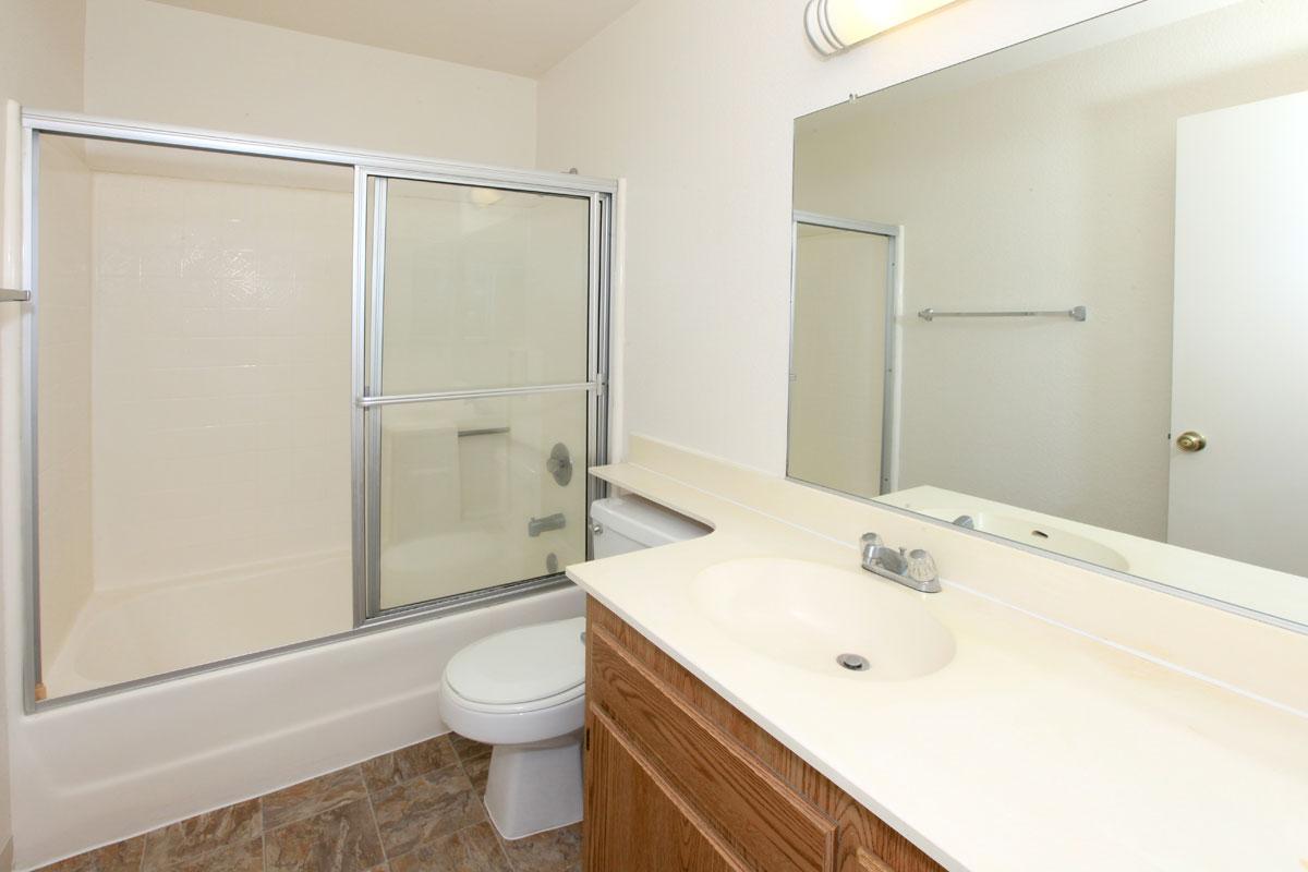 a white sink sitting next to a glass shower door