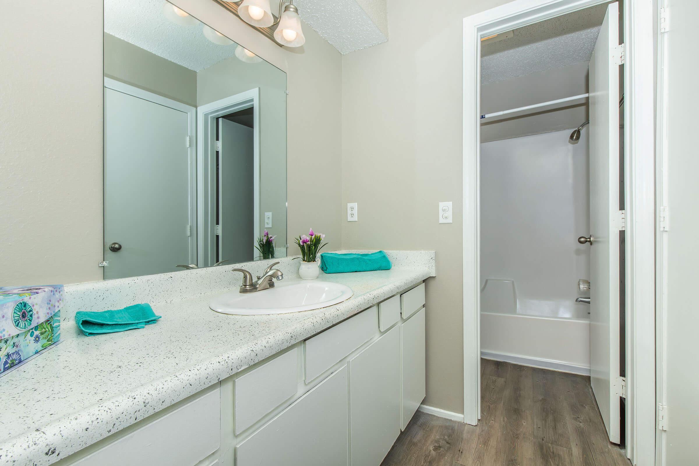 a kitchen with a sink and a mirror