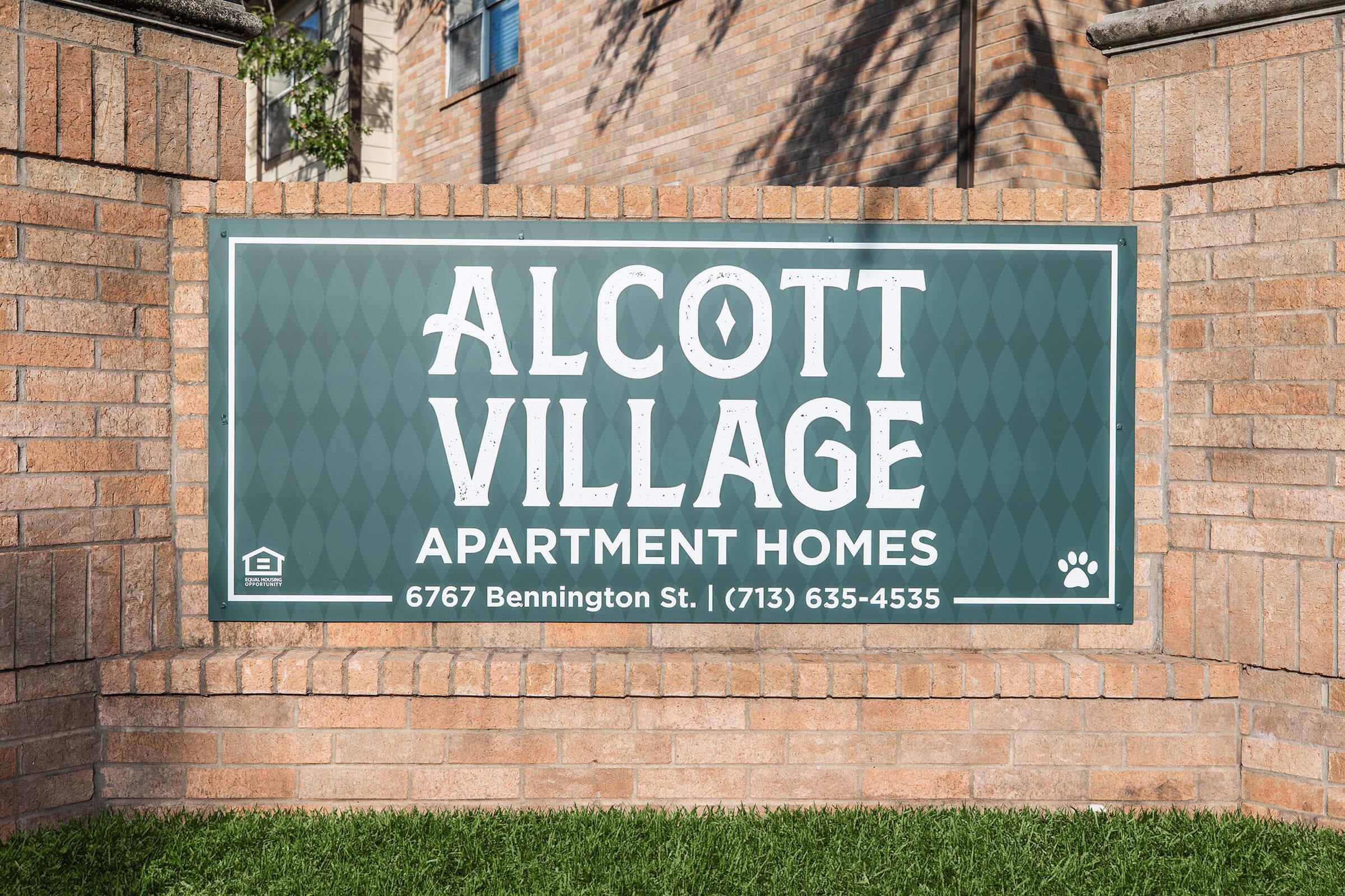 a sign in front of a brick building