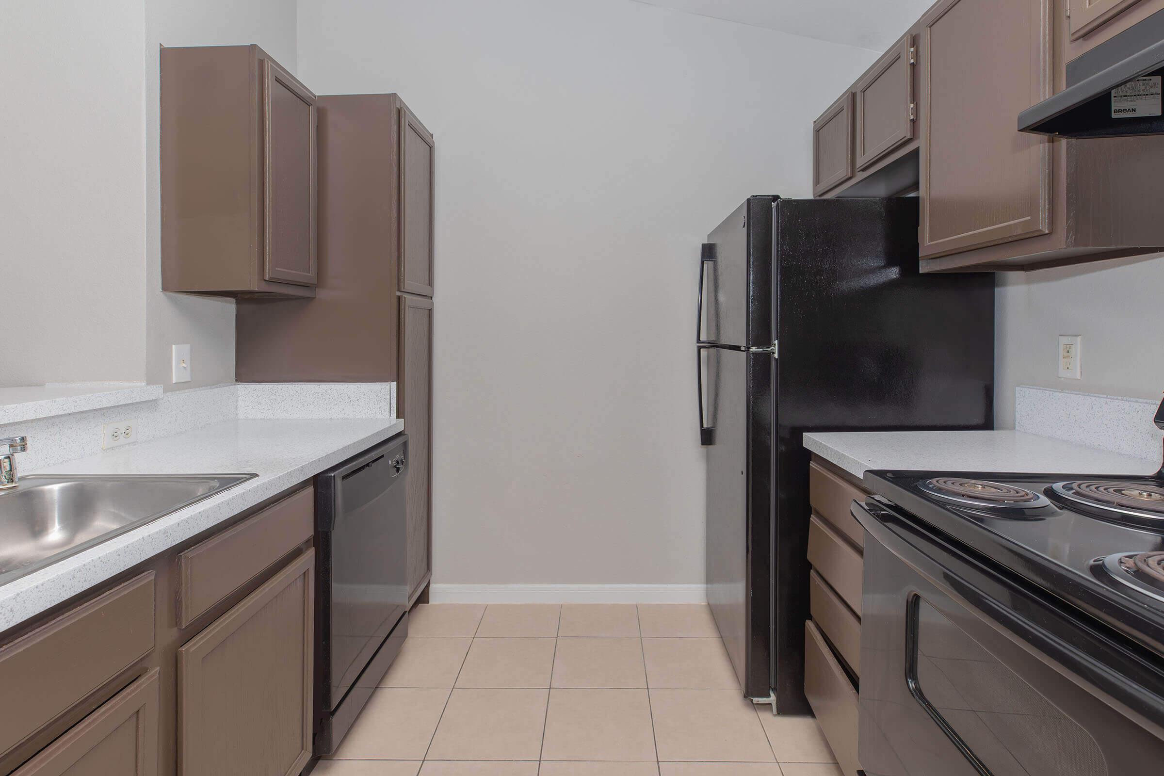 a kitchen with a stove sink and refrigerator