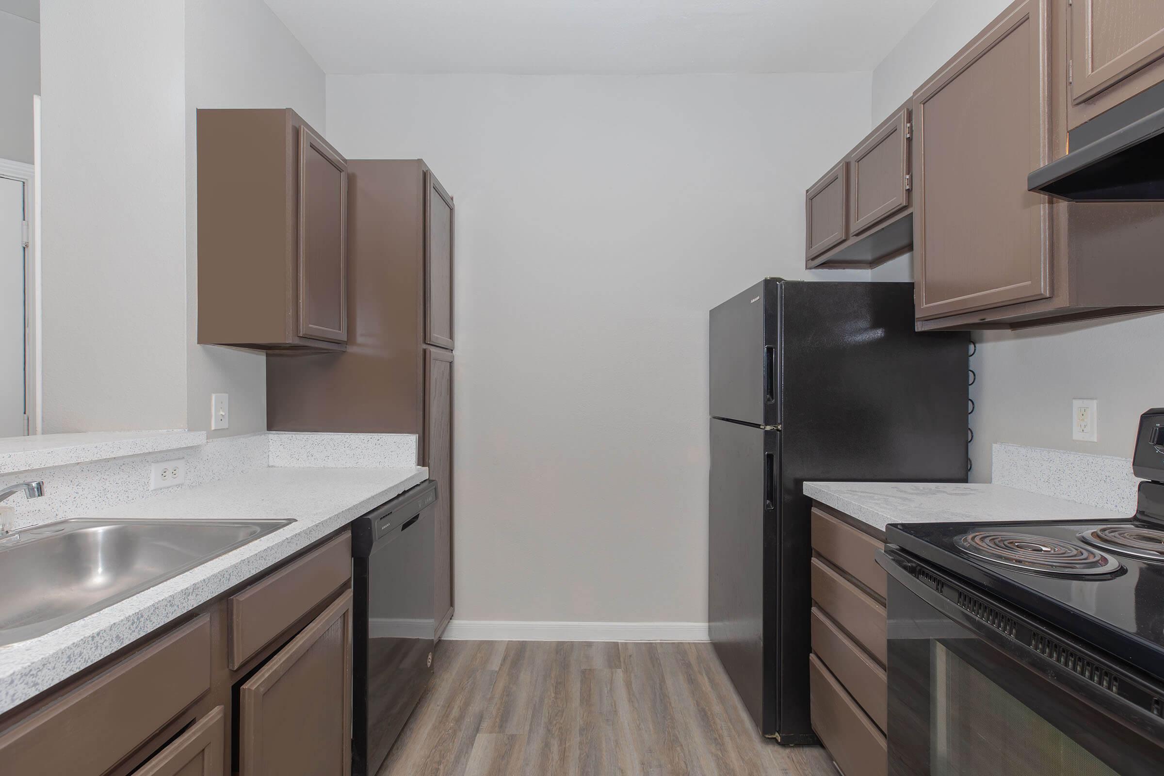 a kitchen with a stove sink and refrigerator