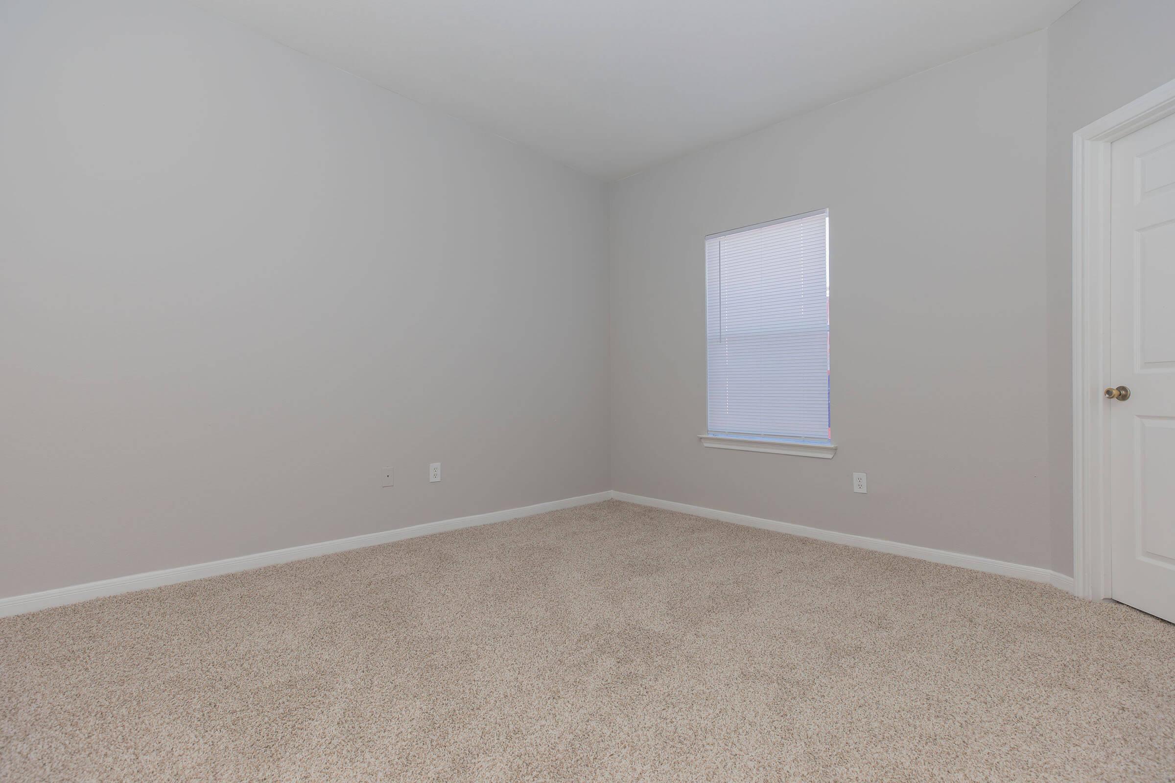 a bedroom with a large window