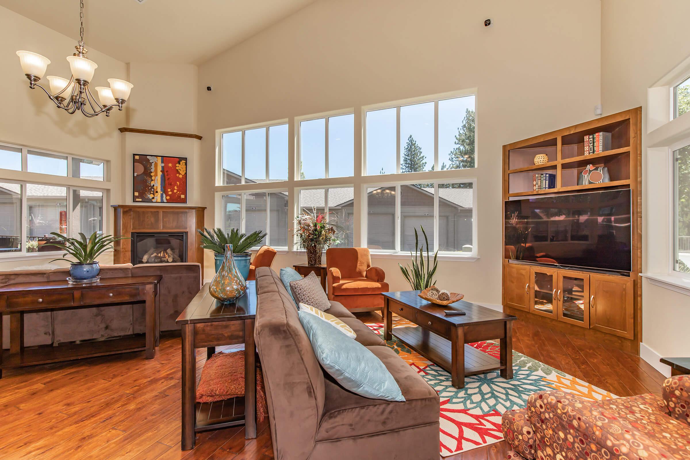 a living room filled with furniture and a large window
