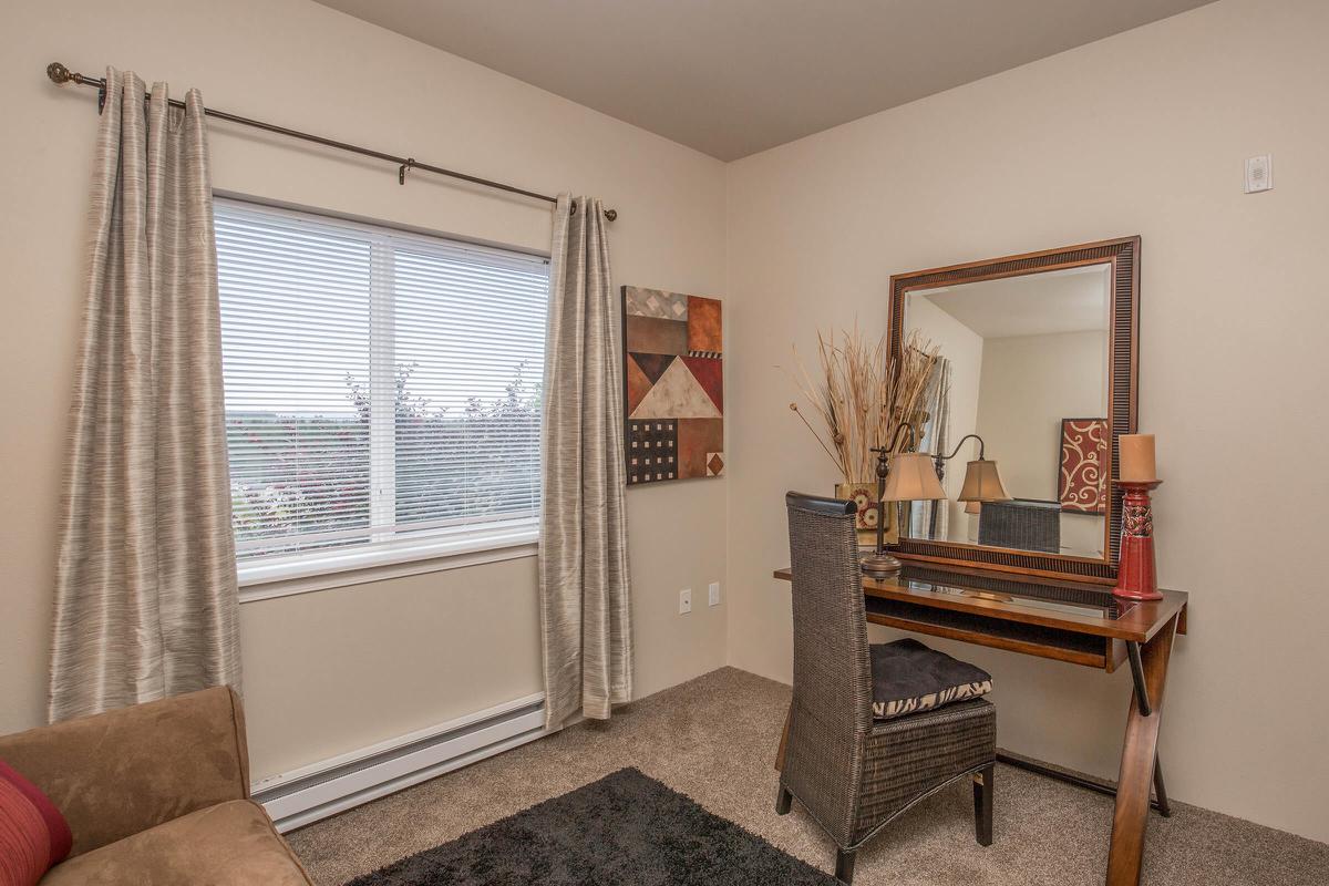 a living room filled with furniture and a large window