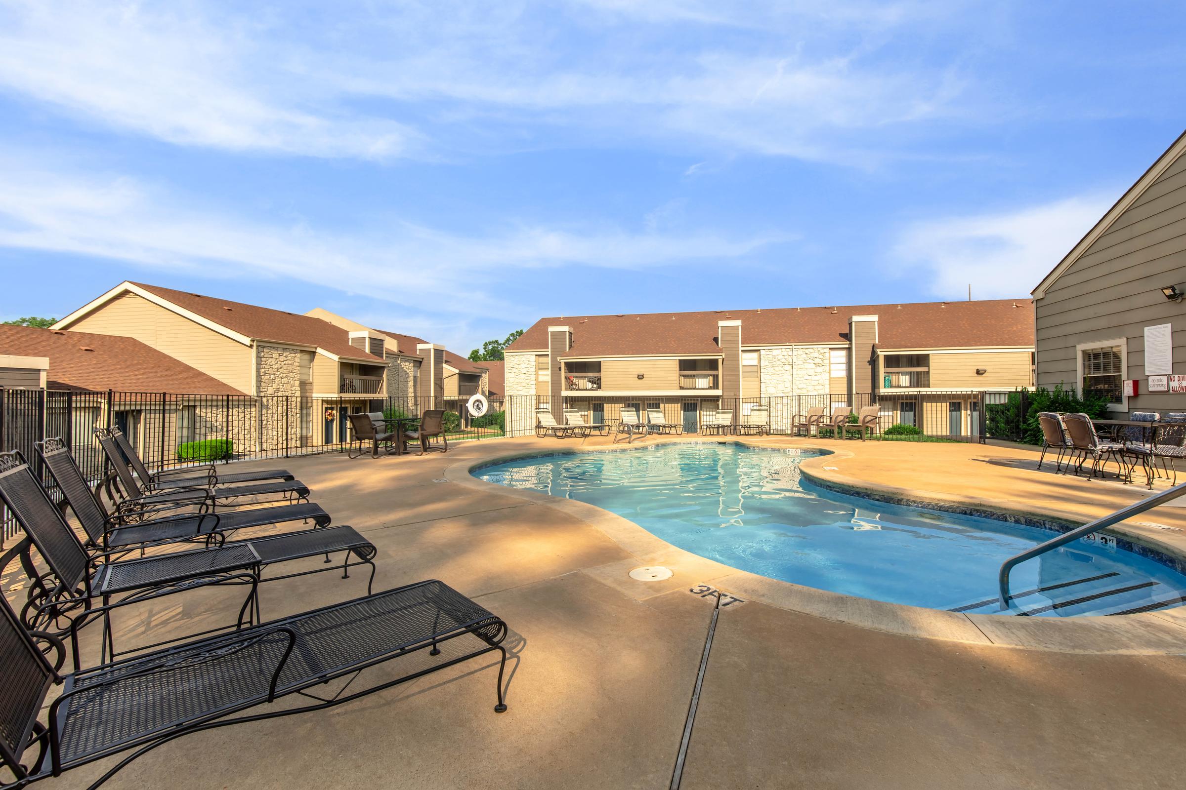 a house with a pool outside of a building