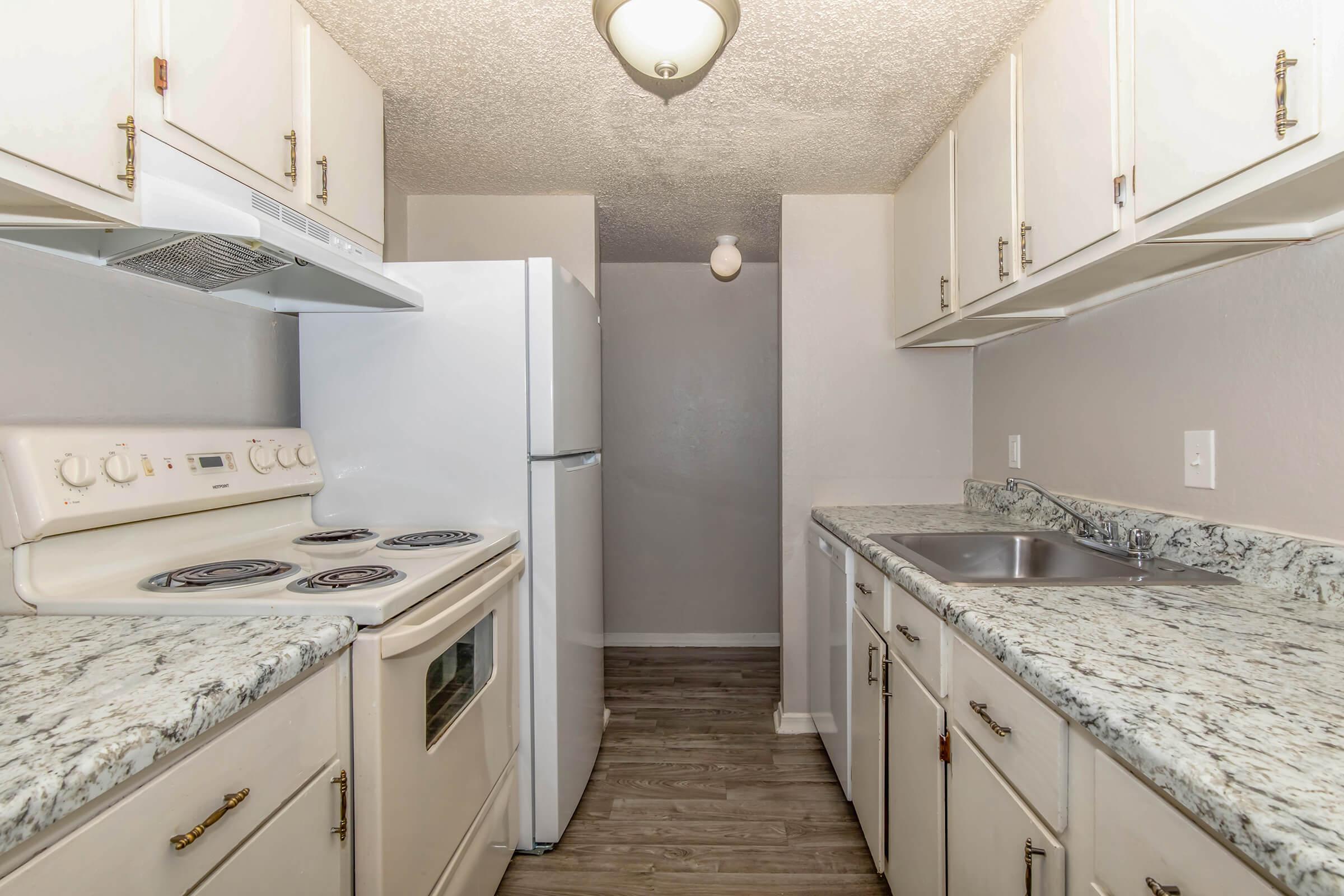 a kitchen with a sink and a mirror