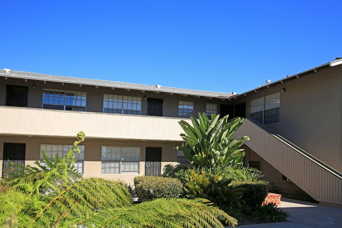 a house with bushes in front of a building