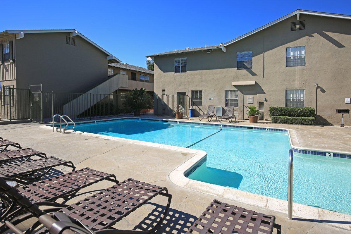 a house with a pool in front of a building